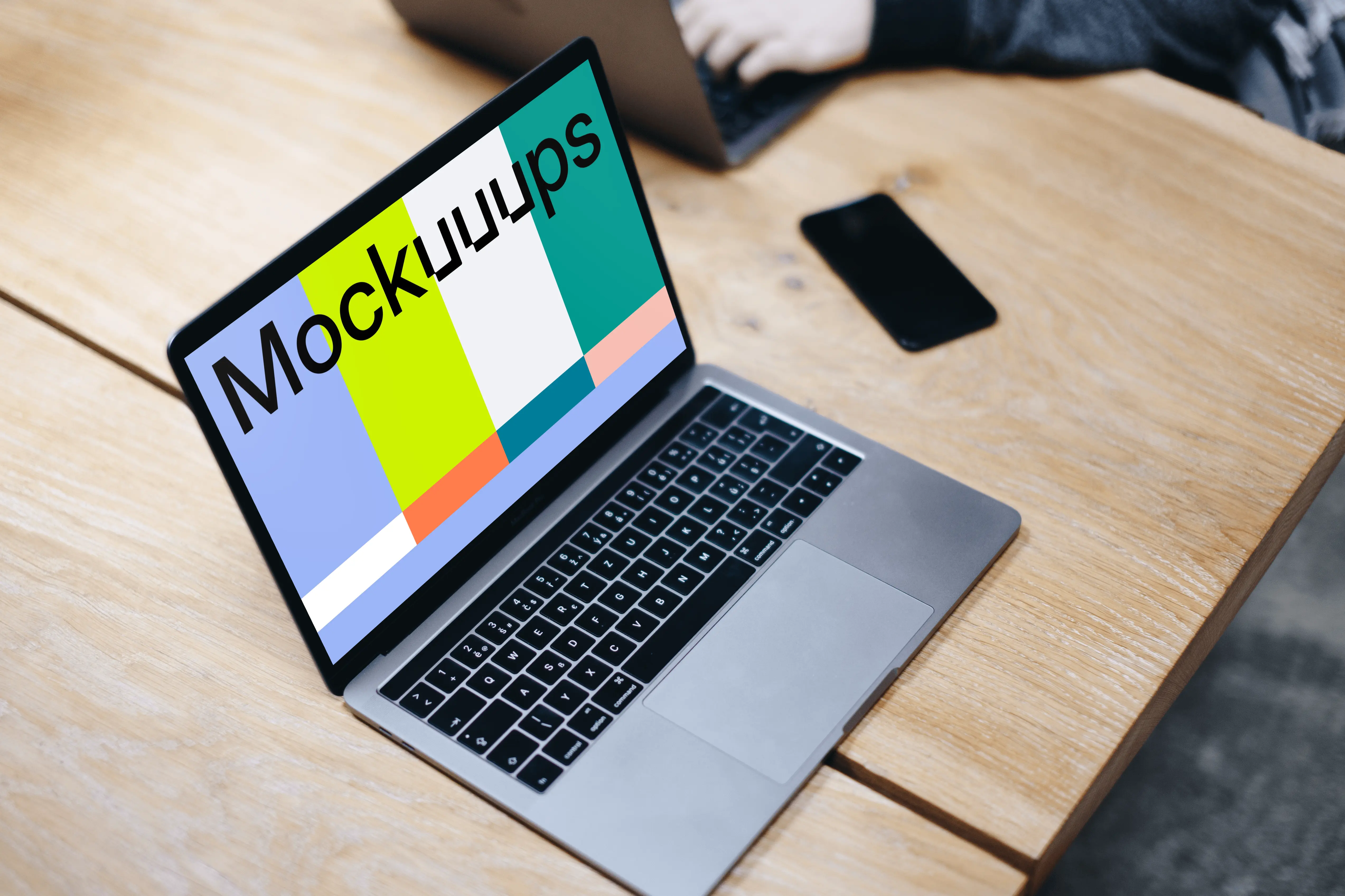 Free Macbook Pro Space Gray mockup on the wooden table