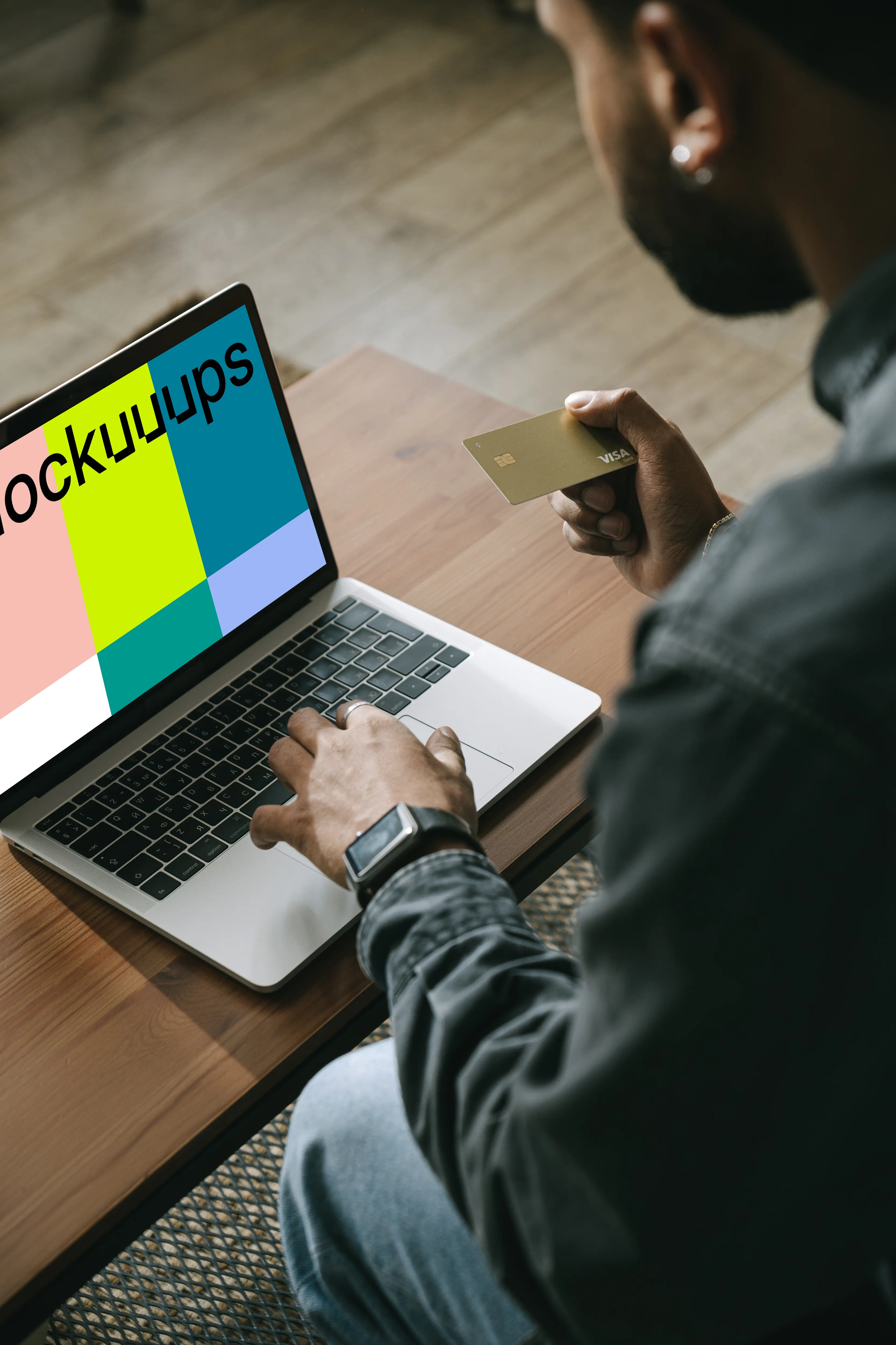 Man making online payment with a Visa card on his MacBook computer mockup.
