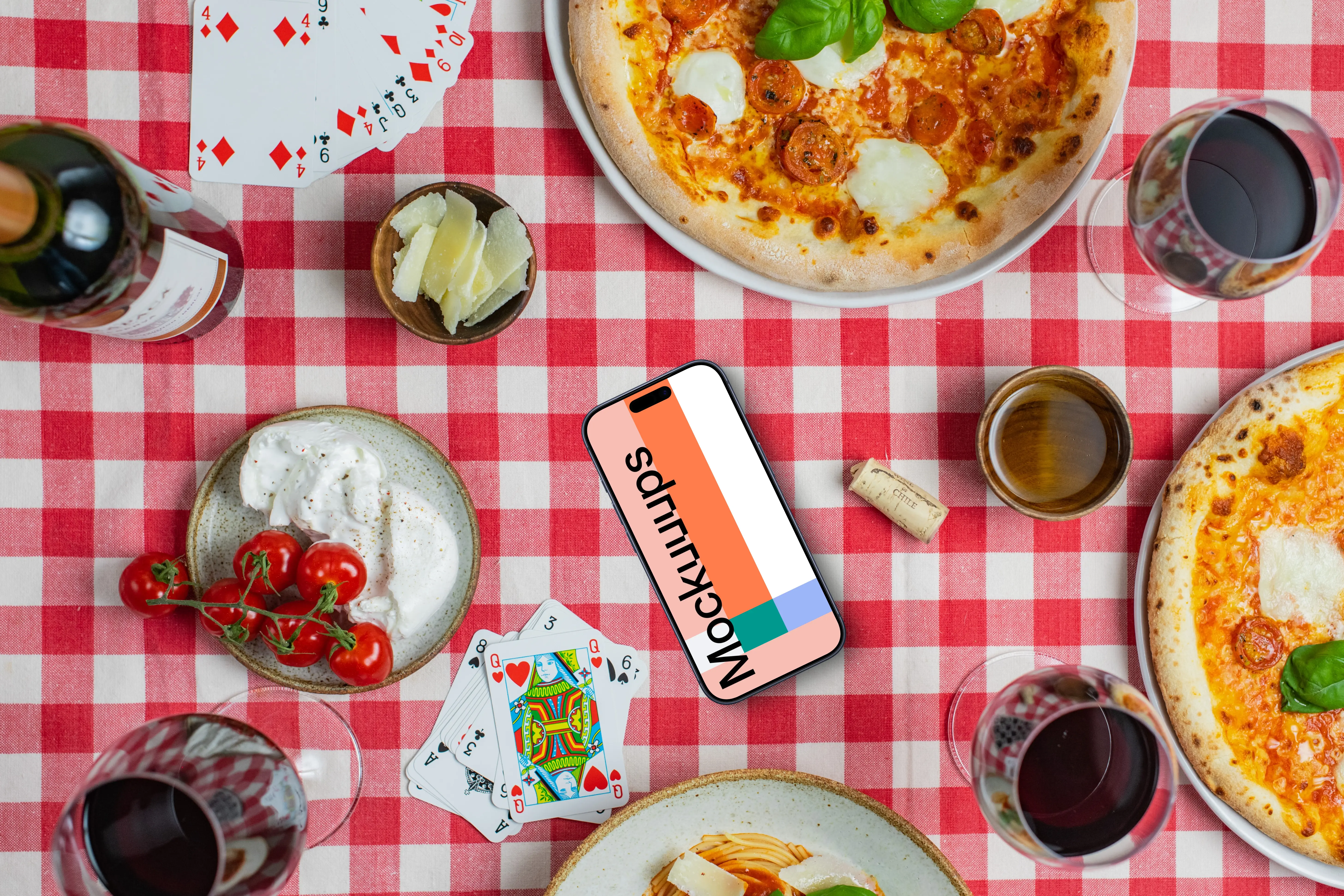 Phone mockup on checkered tablecloth with pizzas