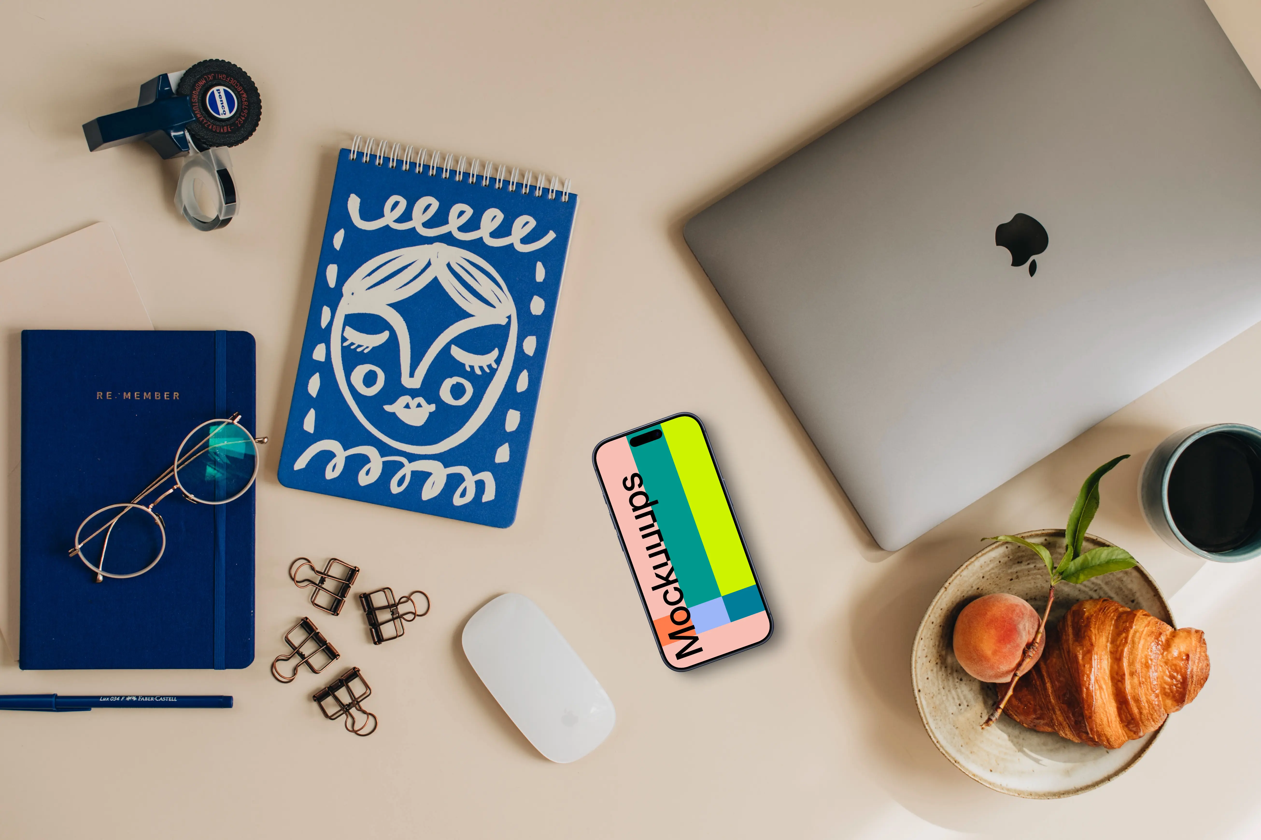 Phone mockup on the desk and laptop on the side