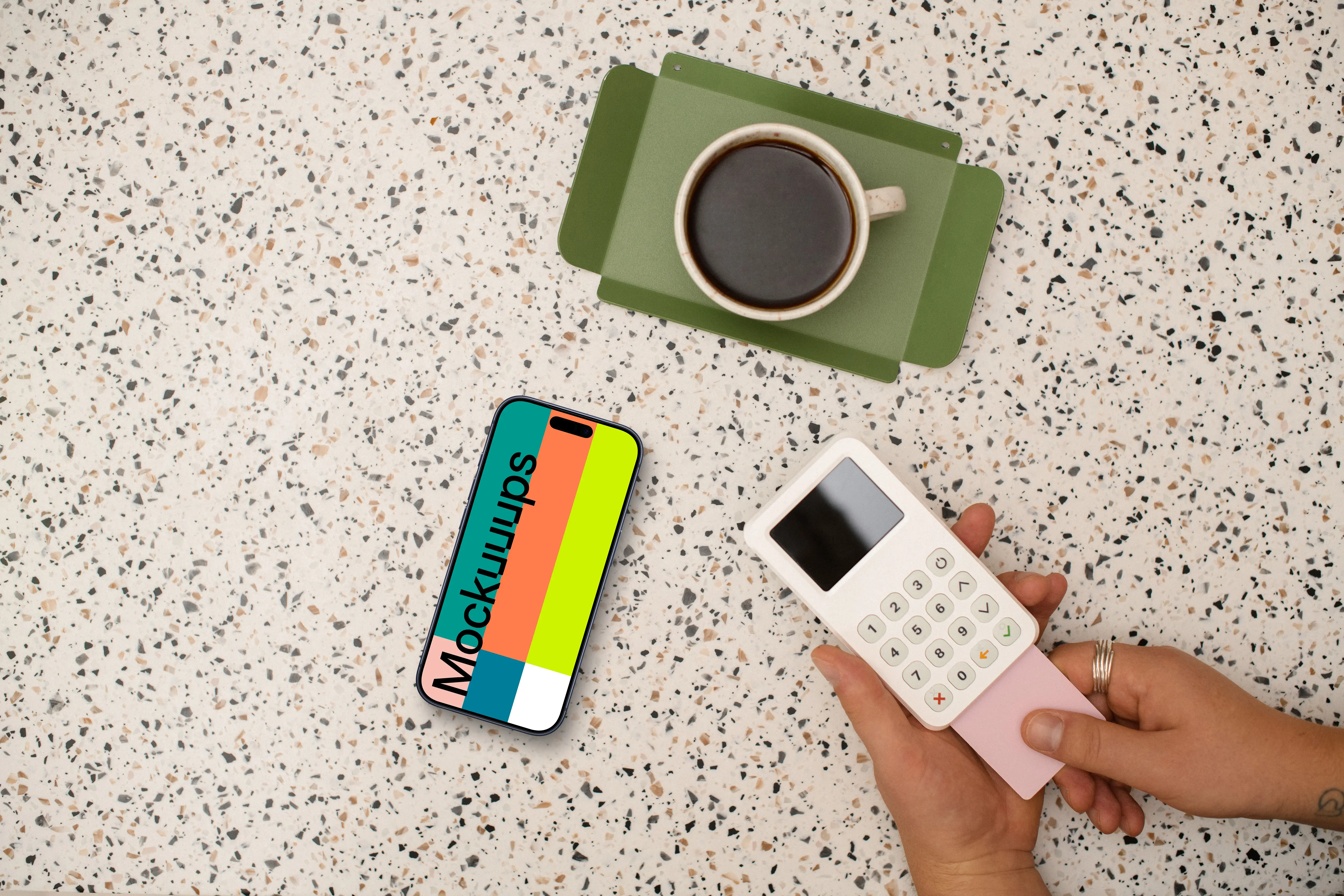 Showcase of coffee shop with an iPhone and credit card terminal