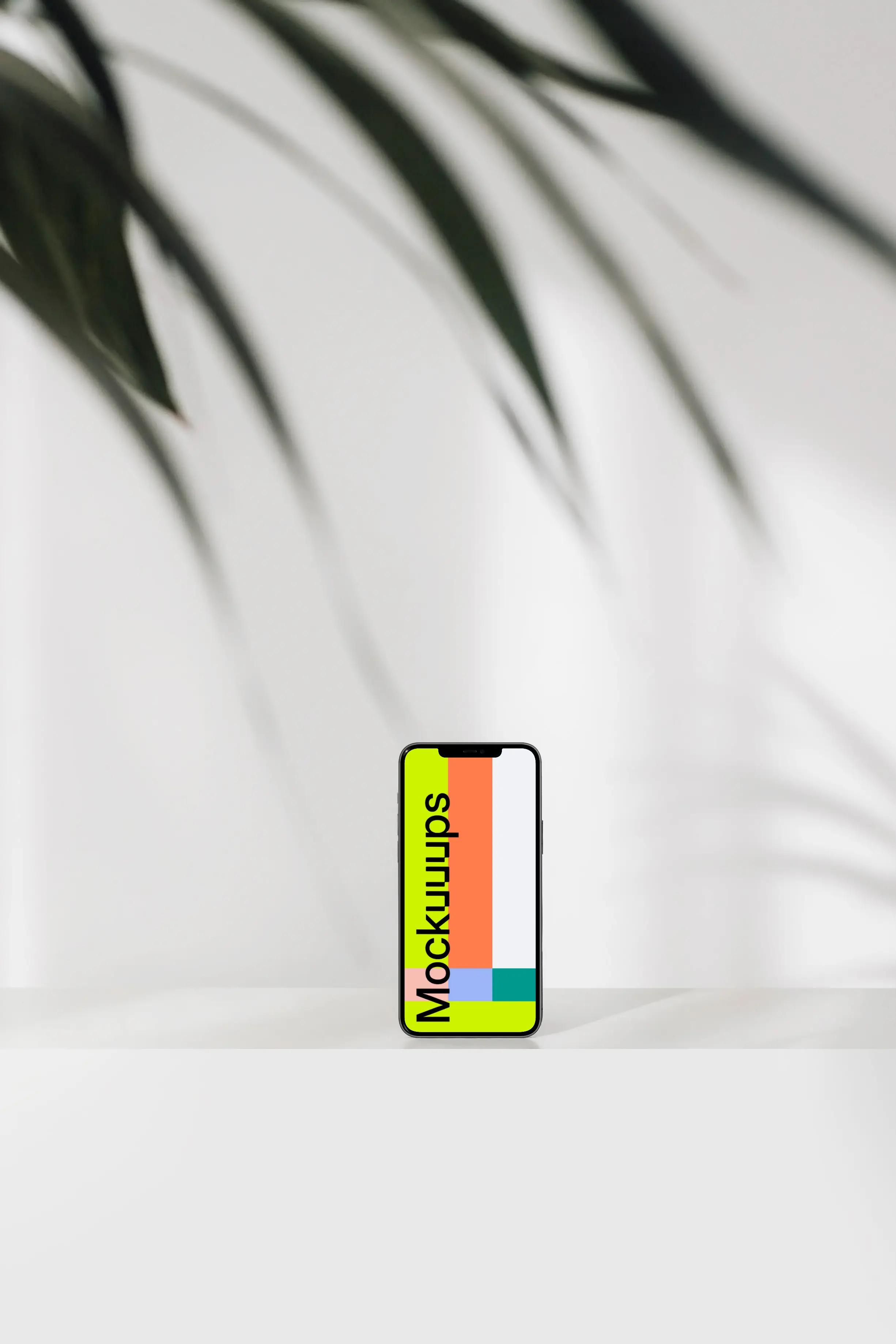 Simple iPhone mockup placed upright with a leaf in the foreground