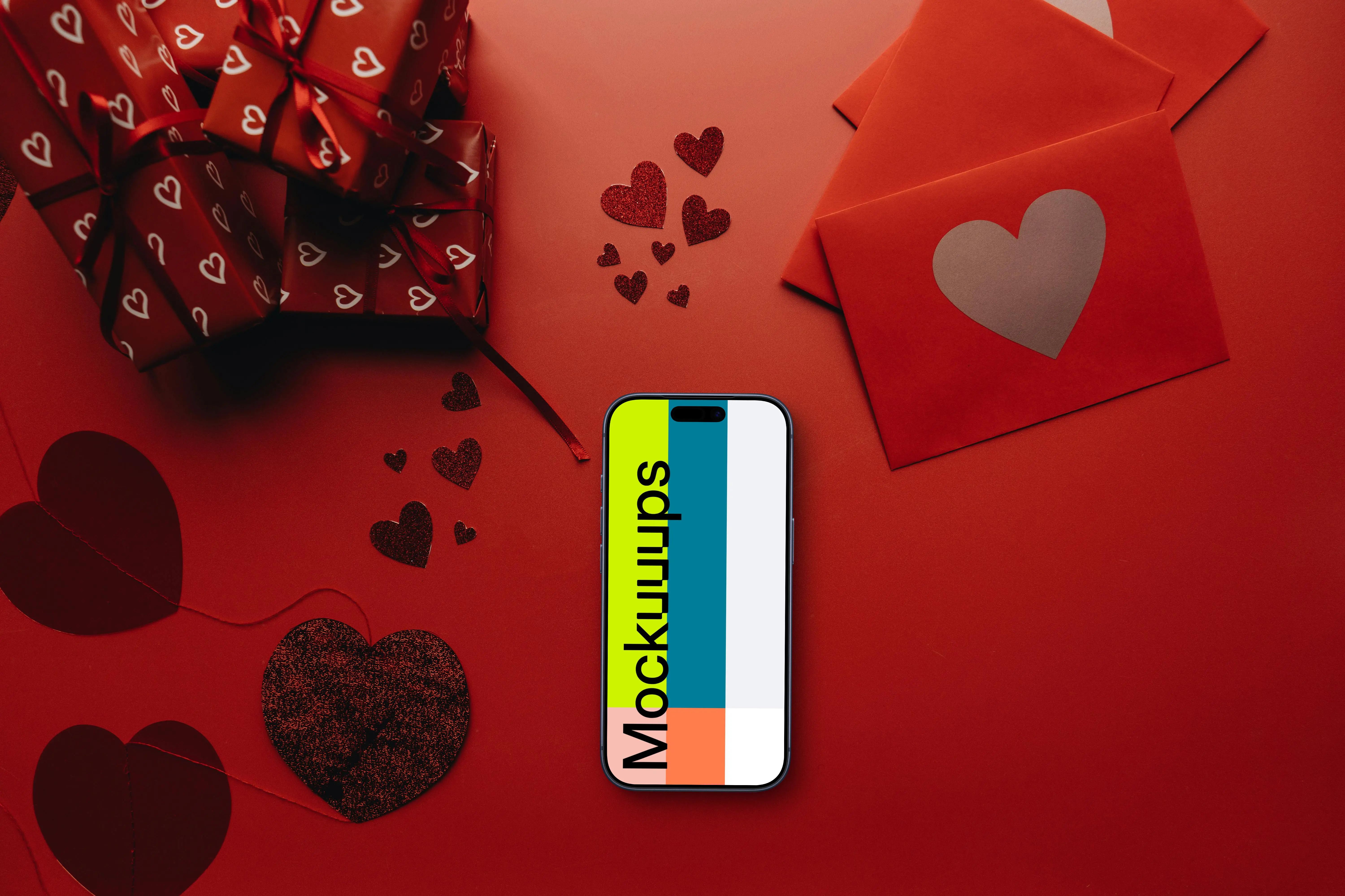 Smartphone mockup in a red scene with hearts and gifts
