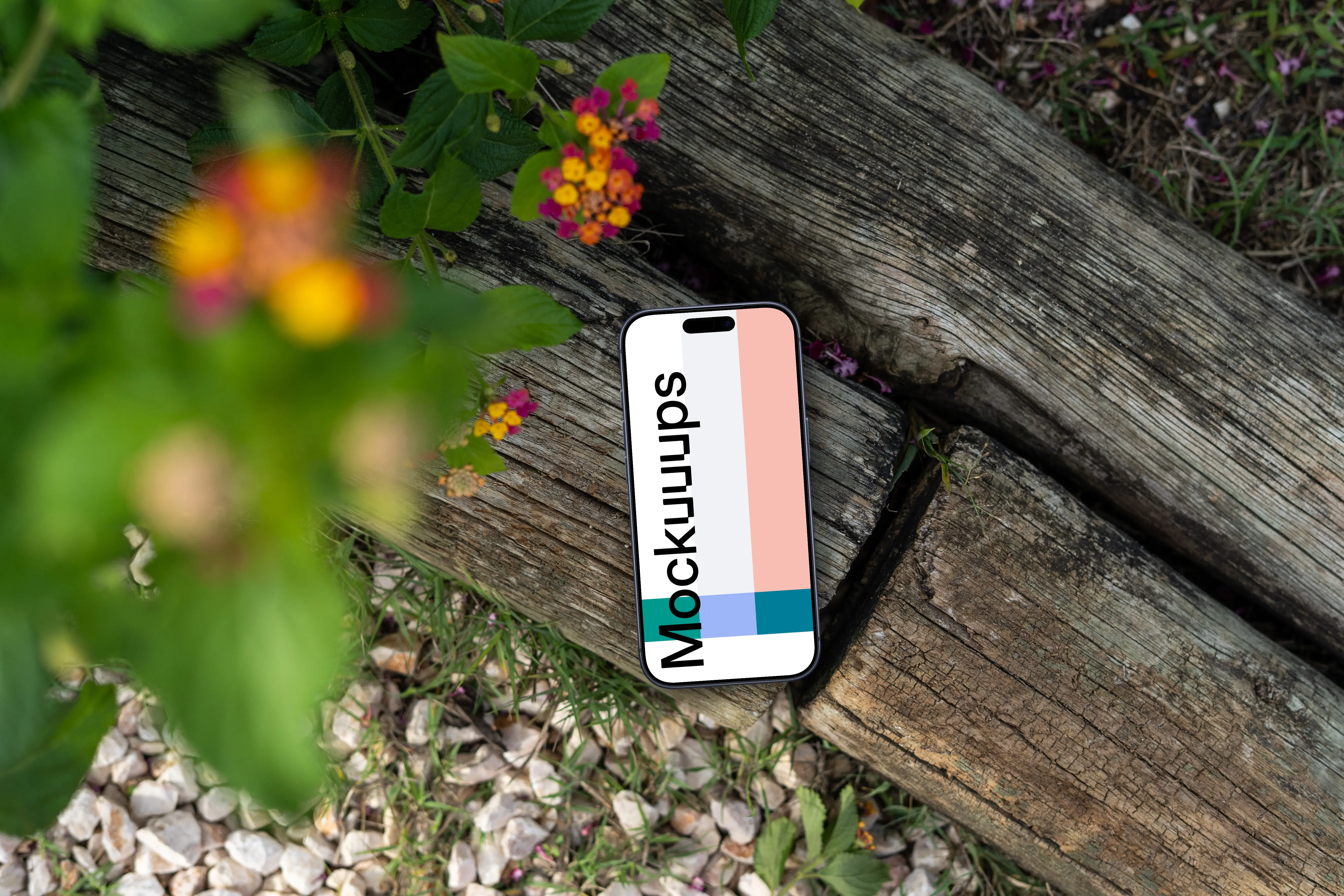 Smartphone mockup laying on wood in a garden