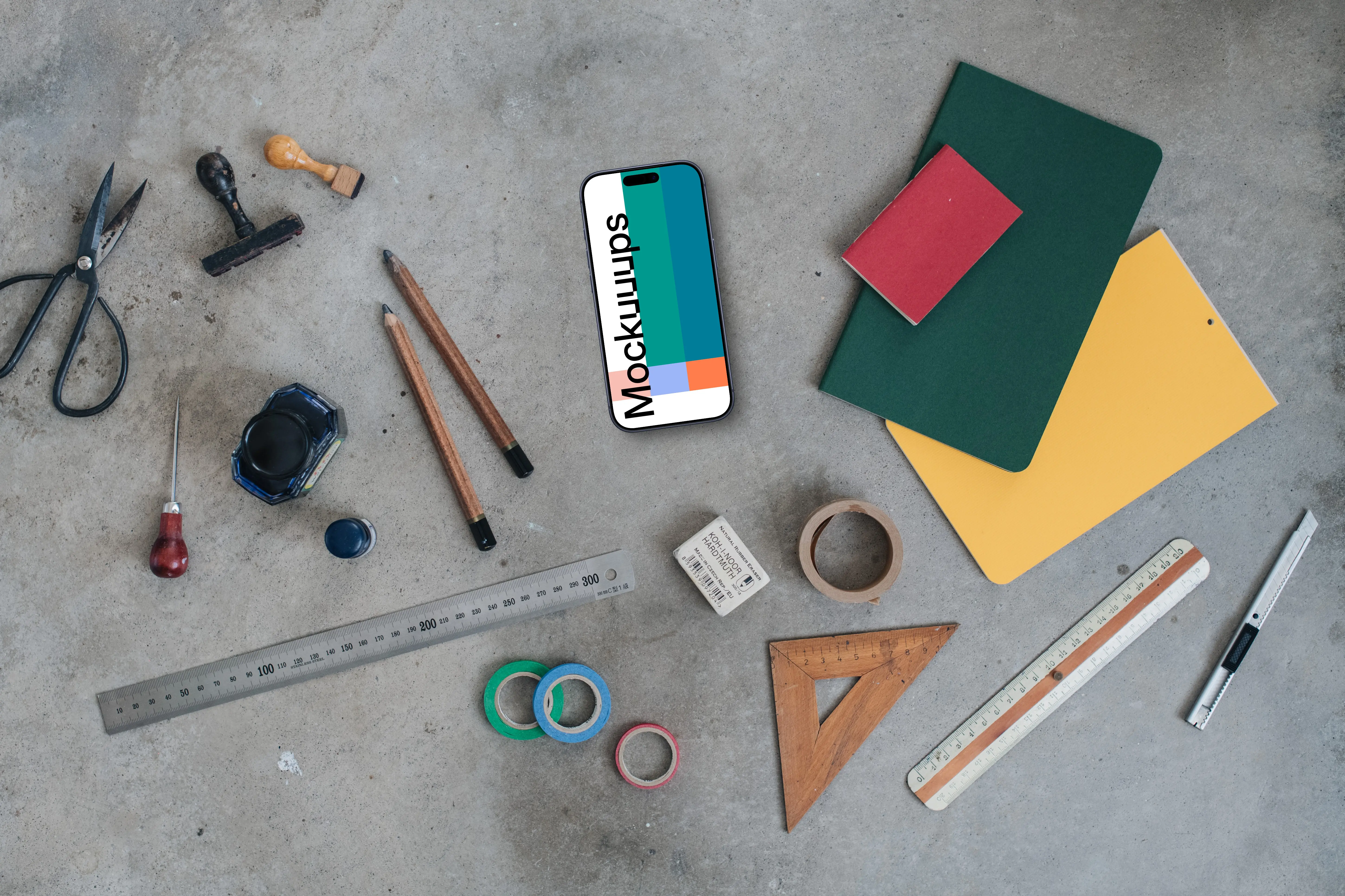 Smartphone mockup next to the colorful notebooks