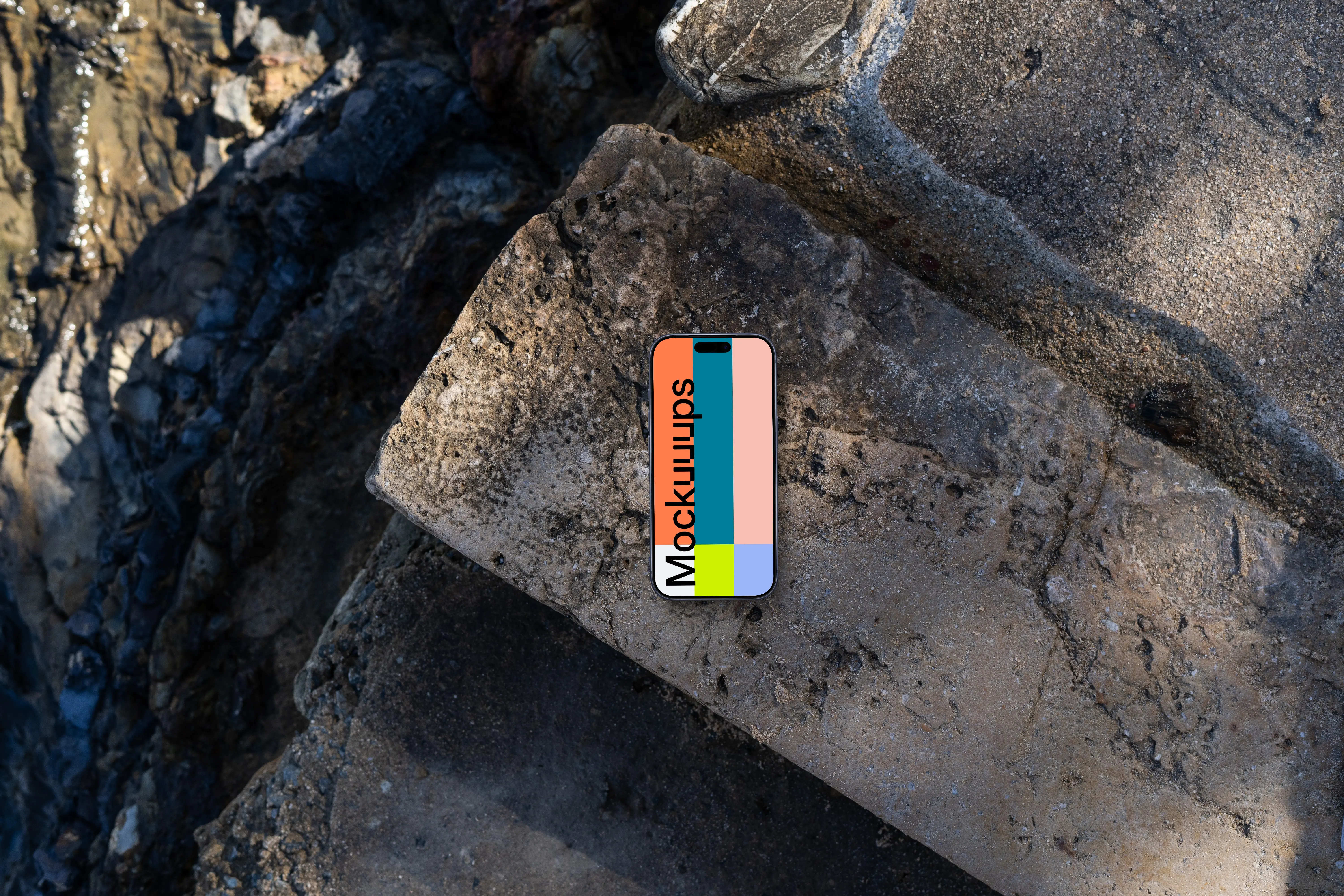 Smartphone mockup on a rocky surface