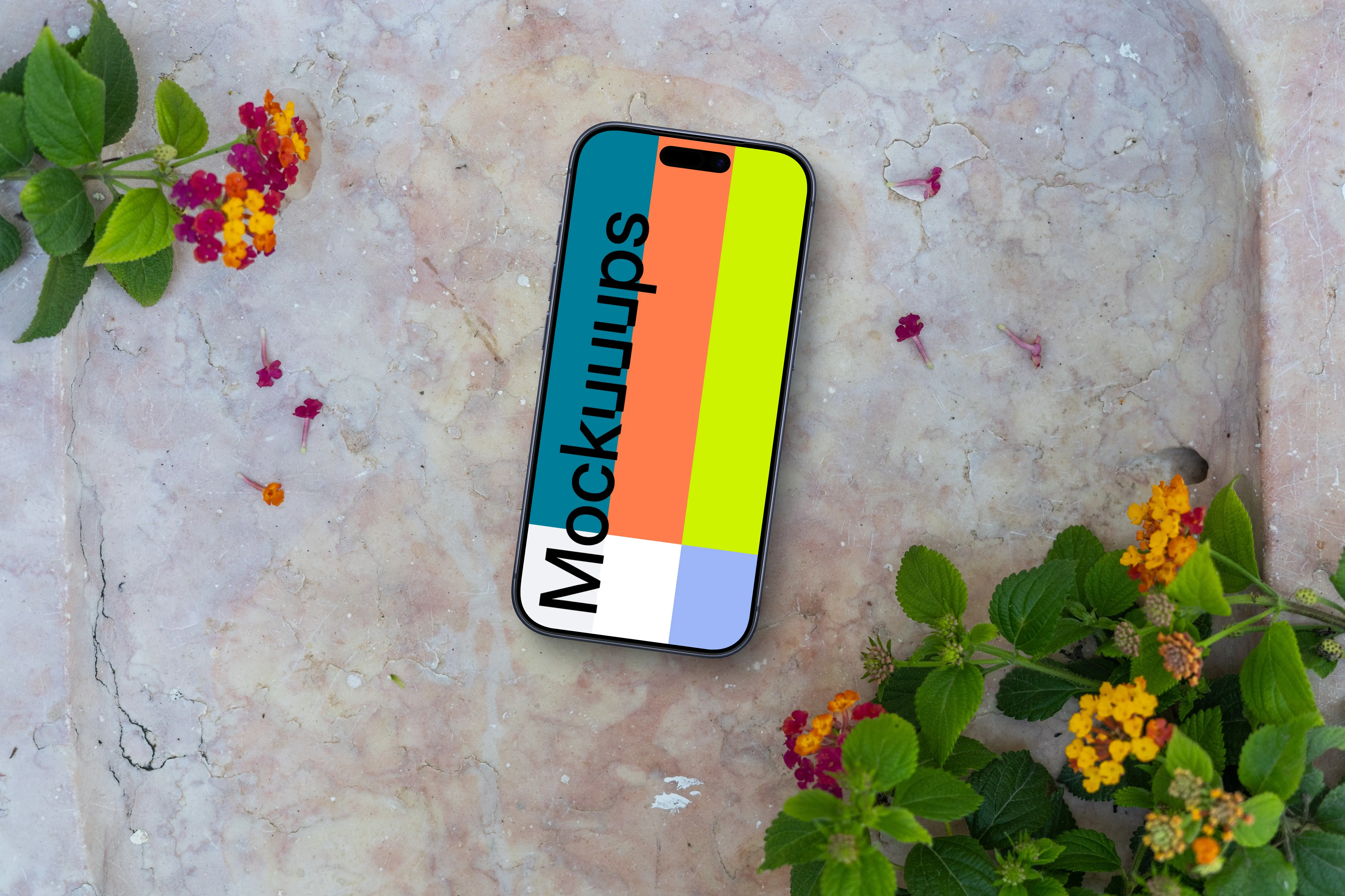 Smartphone mockup on a stone surface with flowers