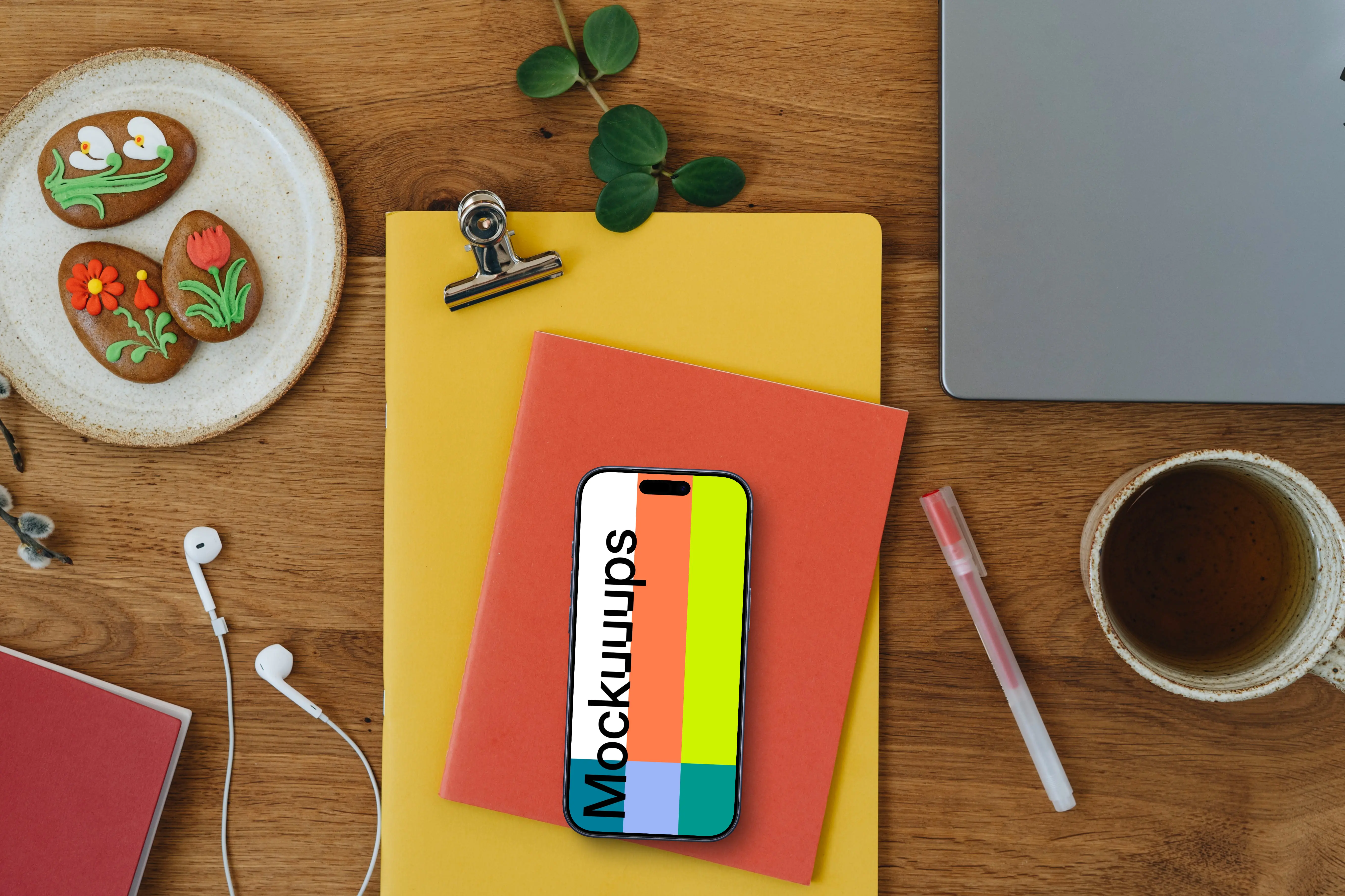 Smartphone mockup on colorful notebooks with Easter gingerbreads