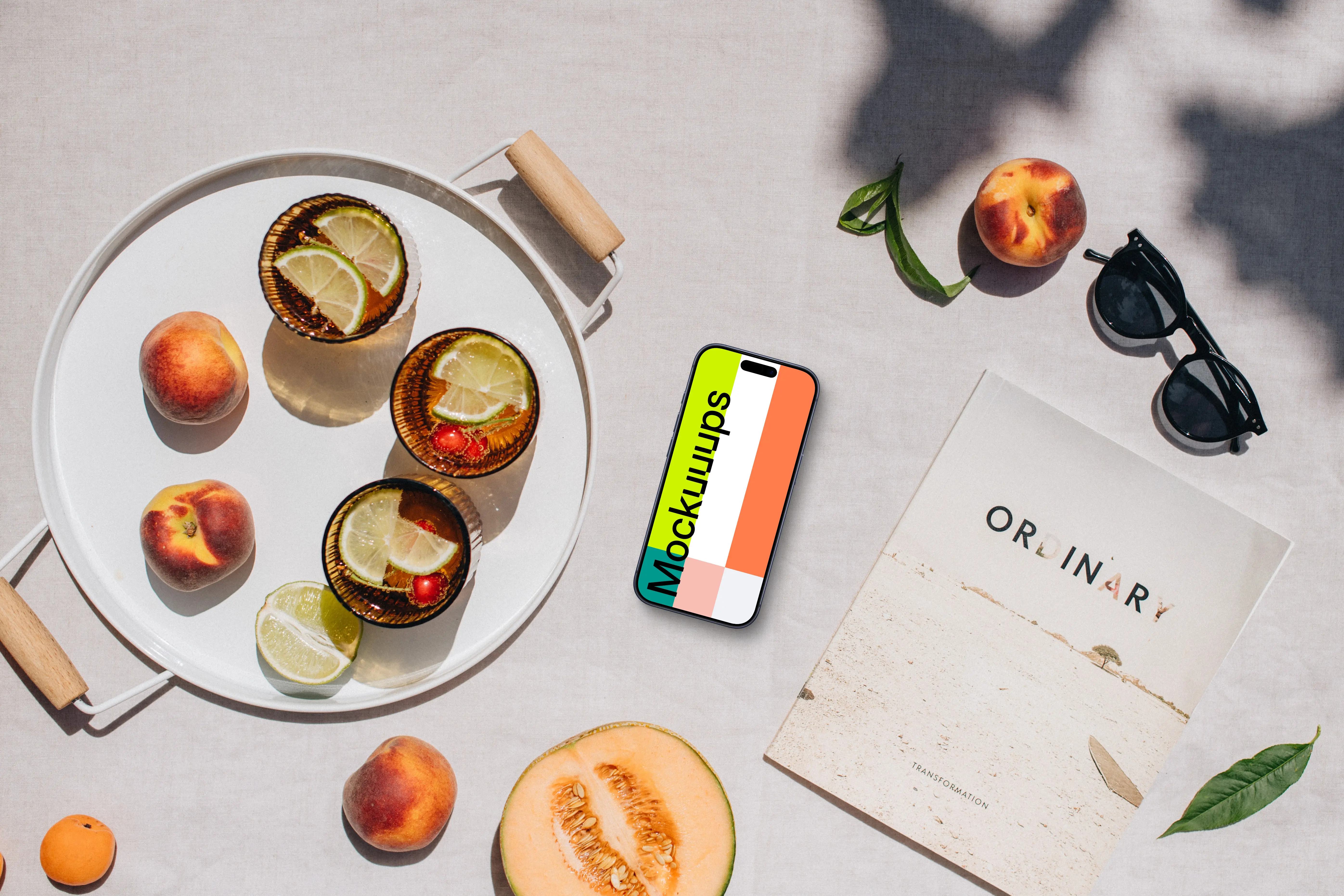 Top view of phone mockup next to the magazine and fresh fruit