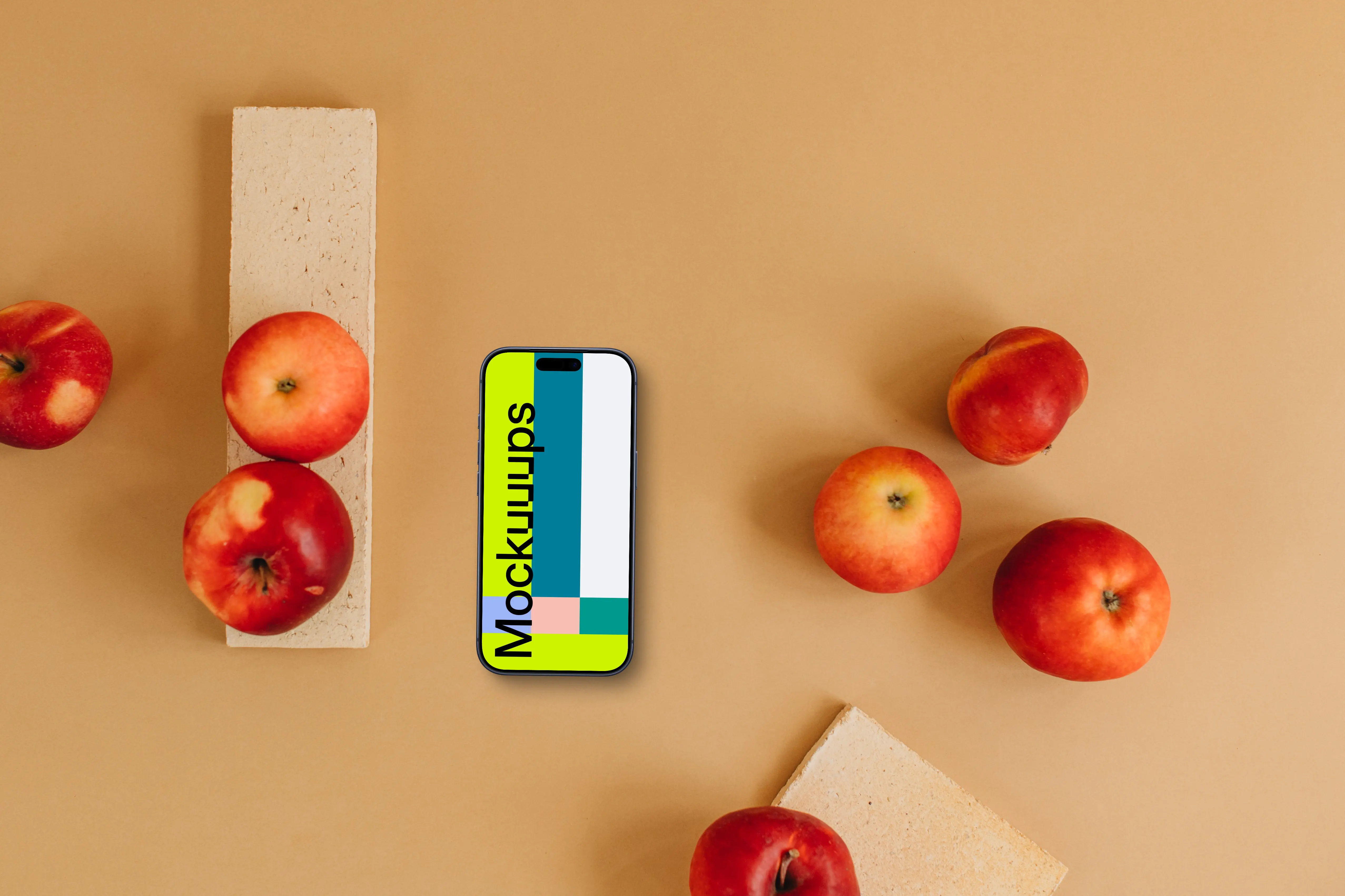 Top view of smartphone mockup next to apples