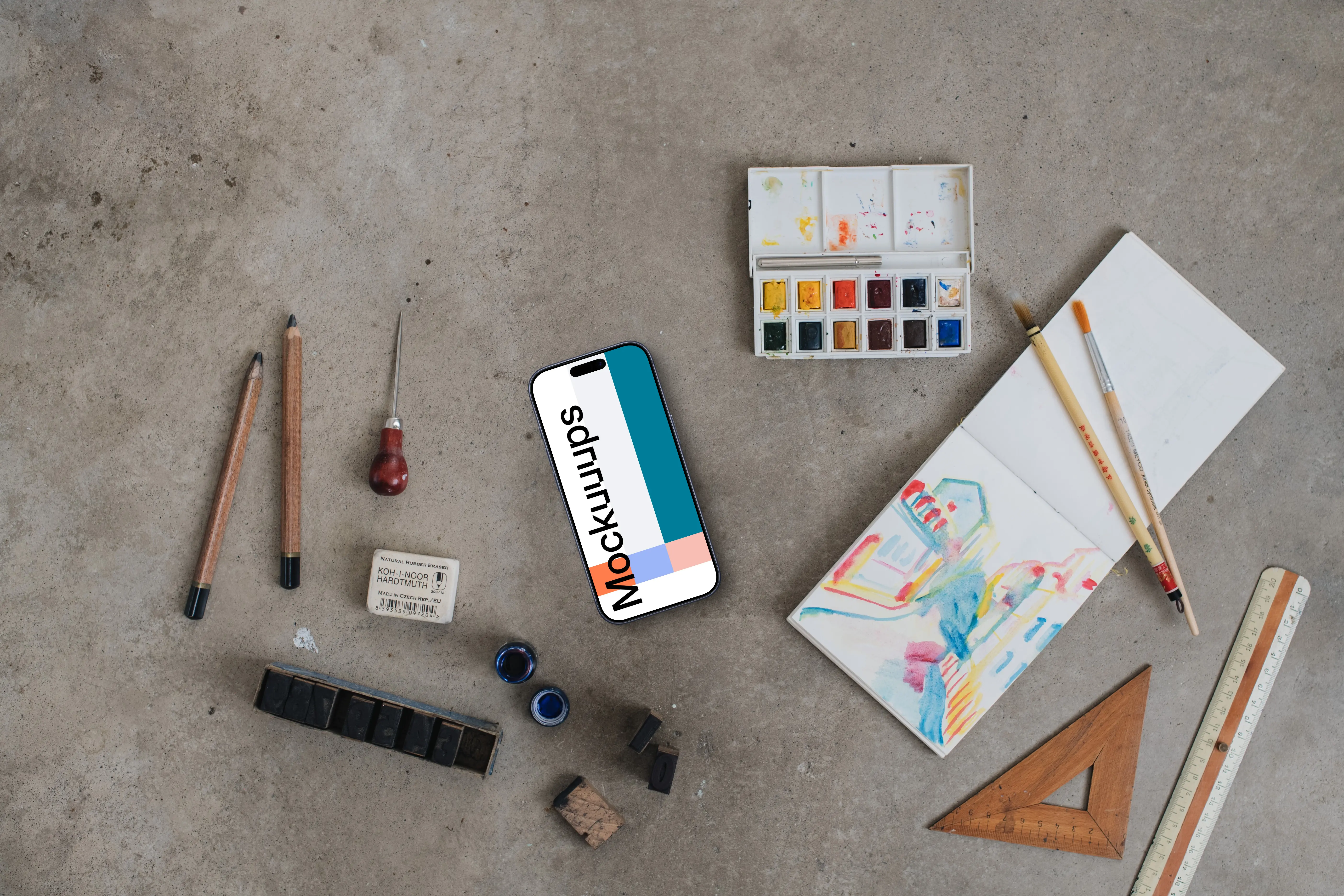 Top view of smartphone mockup next to the painting accessories
