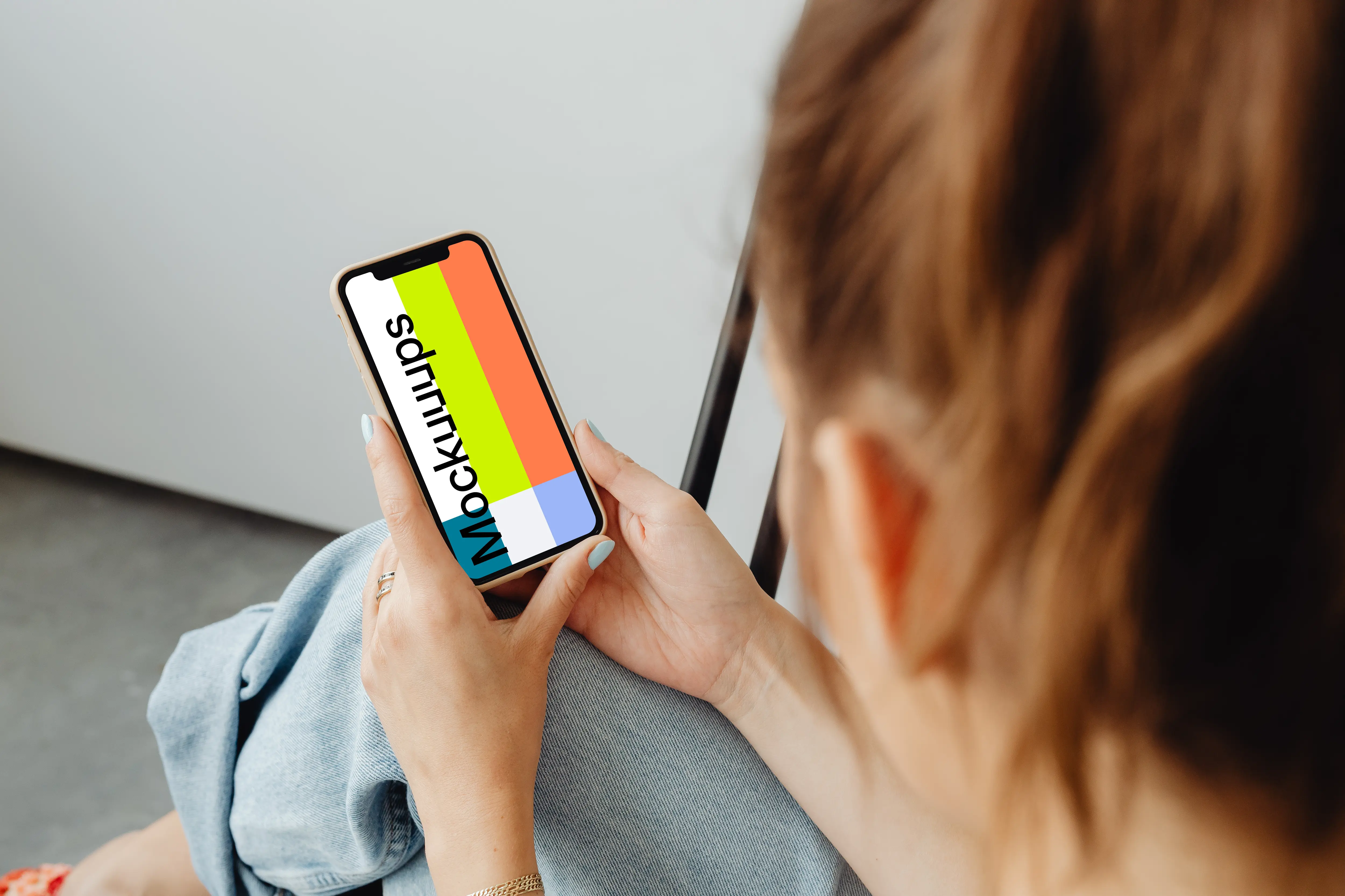 Woman holding iPhone 12 mockup