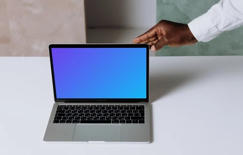 MacBook Pro mockup on a white table in presentation view