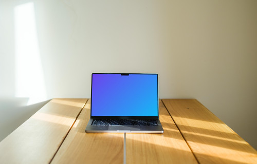 MacBook Pro mockup on a wooden table against a white background