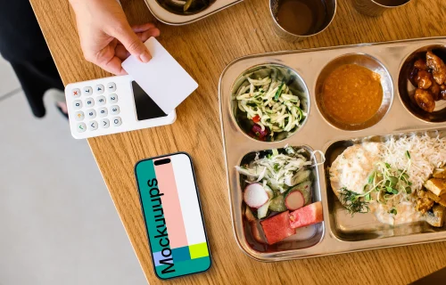 Food plate next to the iPhone mockup and payment terminal