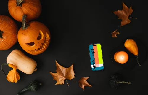 Halloween pumpkin mockup with a phone on the dark background
