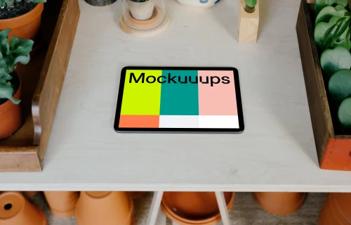 iPad Air mockup on a table with potted plants