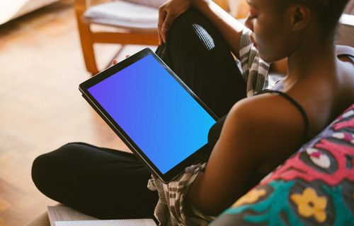 iPad Pro mockup in dark-skinned black lady's hand for study