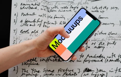 iPhone 12 Pro mockup held over a sheet of paper