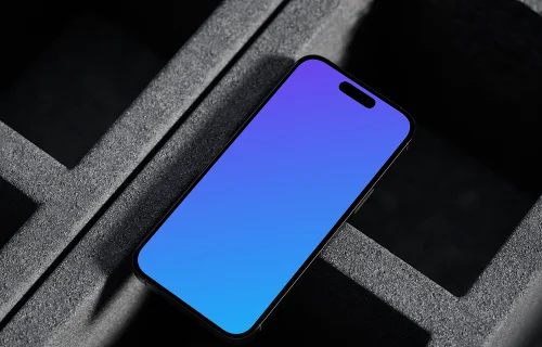 iPhone 16 mockup on concrete backdrop