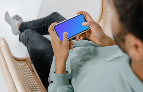 iPhone mockup held by user in landscape mode