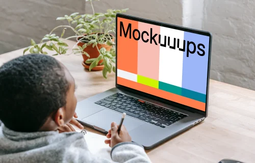 Kid studying with a gray MacBook Pro mockup