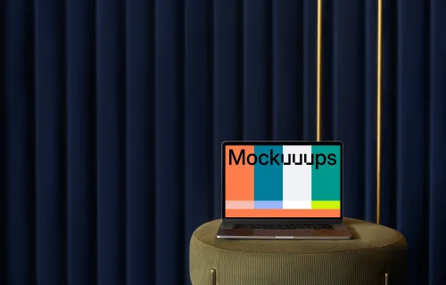 MacBook mockup on a stool with a blue curtain in the background