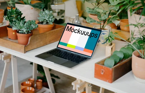 MacBook Pro Mockup between potted plants