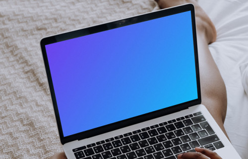 MacBook Pro mockup on a ladies lap sitting on a bed