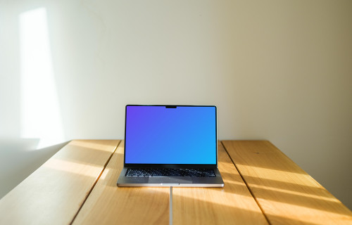 MacBook Pro mockup on a wooden table against a white background