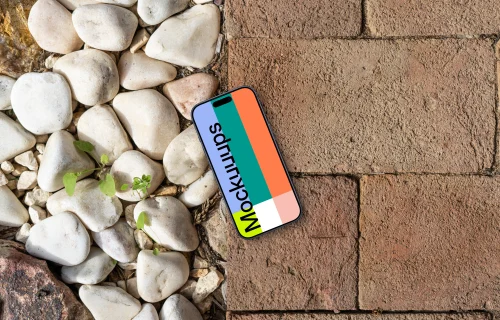 Smartphone mockup laying on a brick path