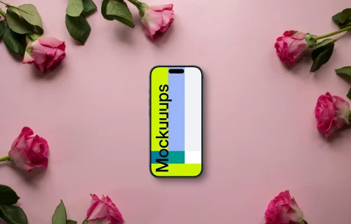 Smartphone mockup on a pink background among roses