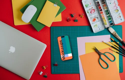 Smartphone mockup with school equipment on the table