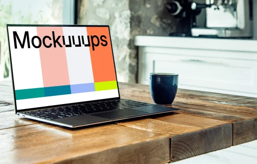 Dell XPS mockup on table with coffee mug at the side