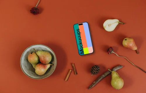 Top view of phone mockup on the dark orange background