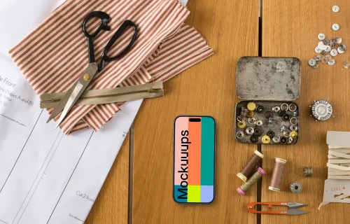 Top view of phone mockup with sewing accessories
