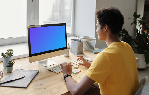 Young boy smiling at an iMac mockup