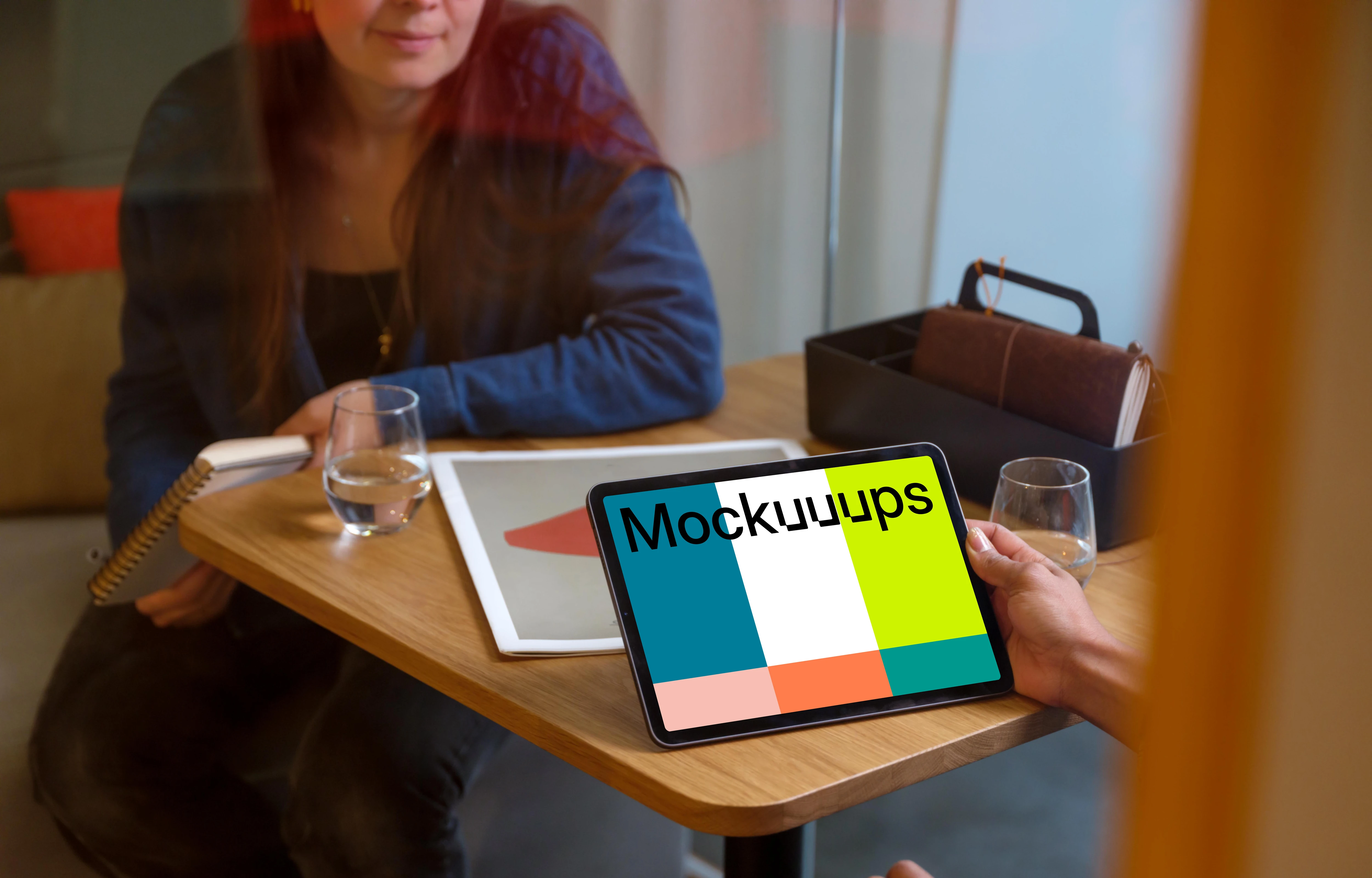 Hand holding an iPad Air mockup in office