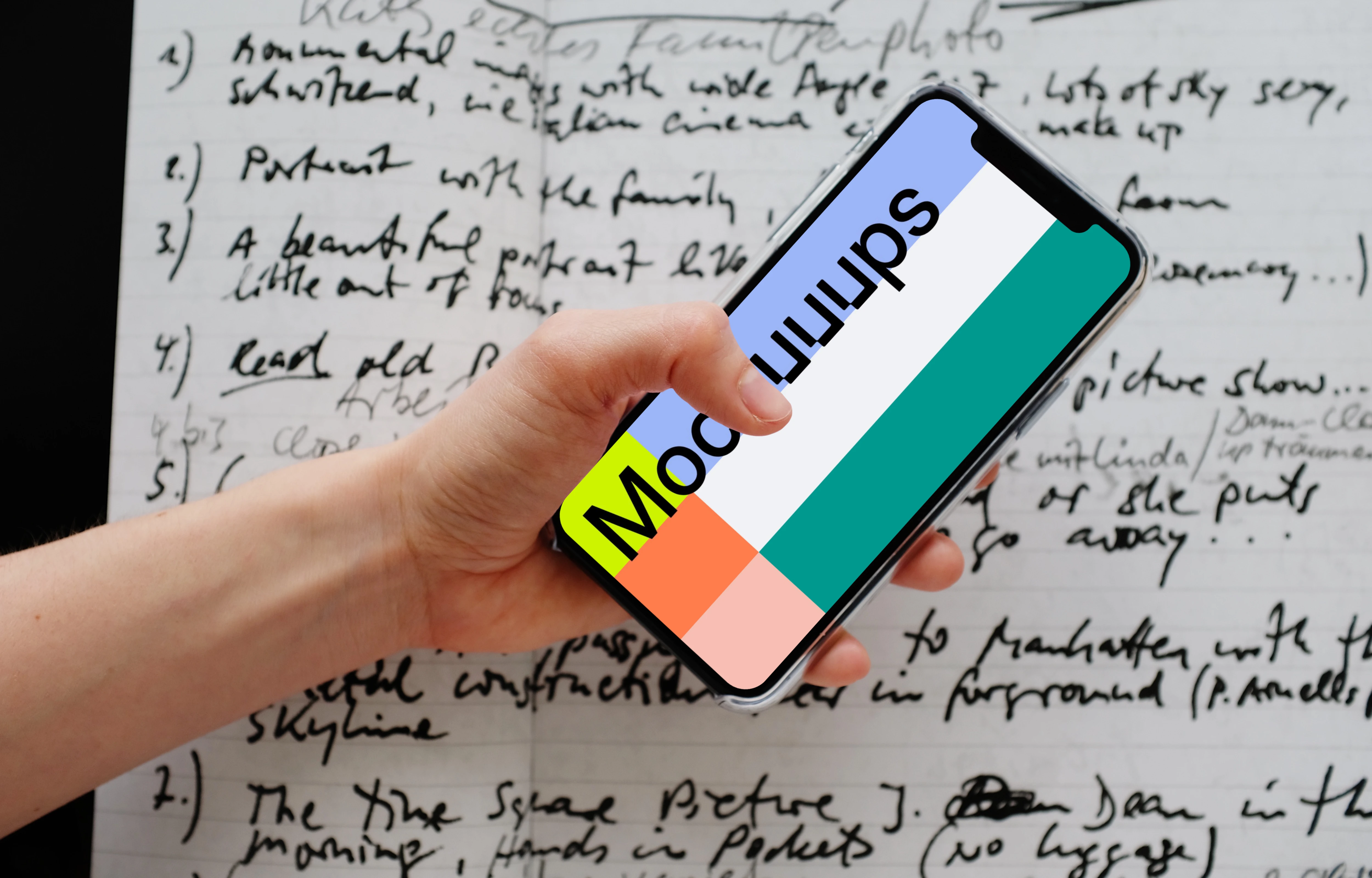 iPhone 12 Pro mockup held over a sheet of paper