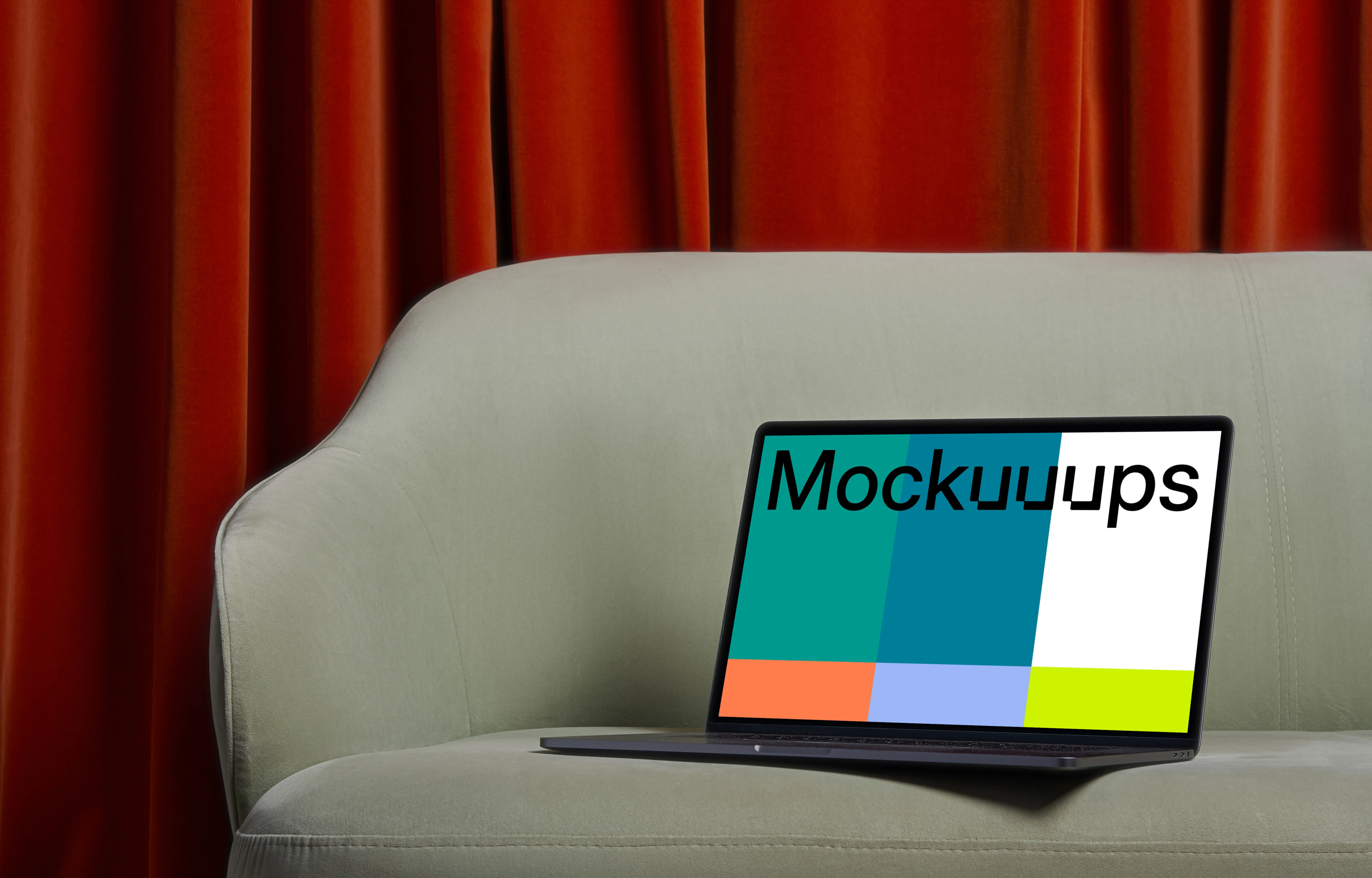 MacBook mockup on a couch with a red curtain in the background