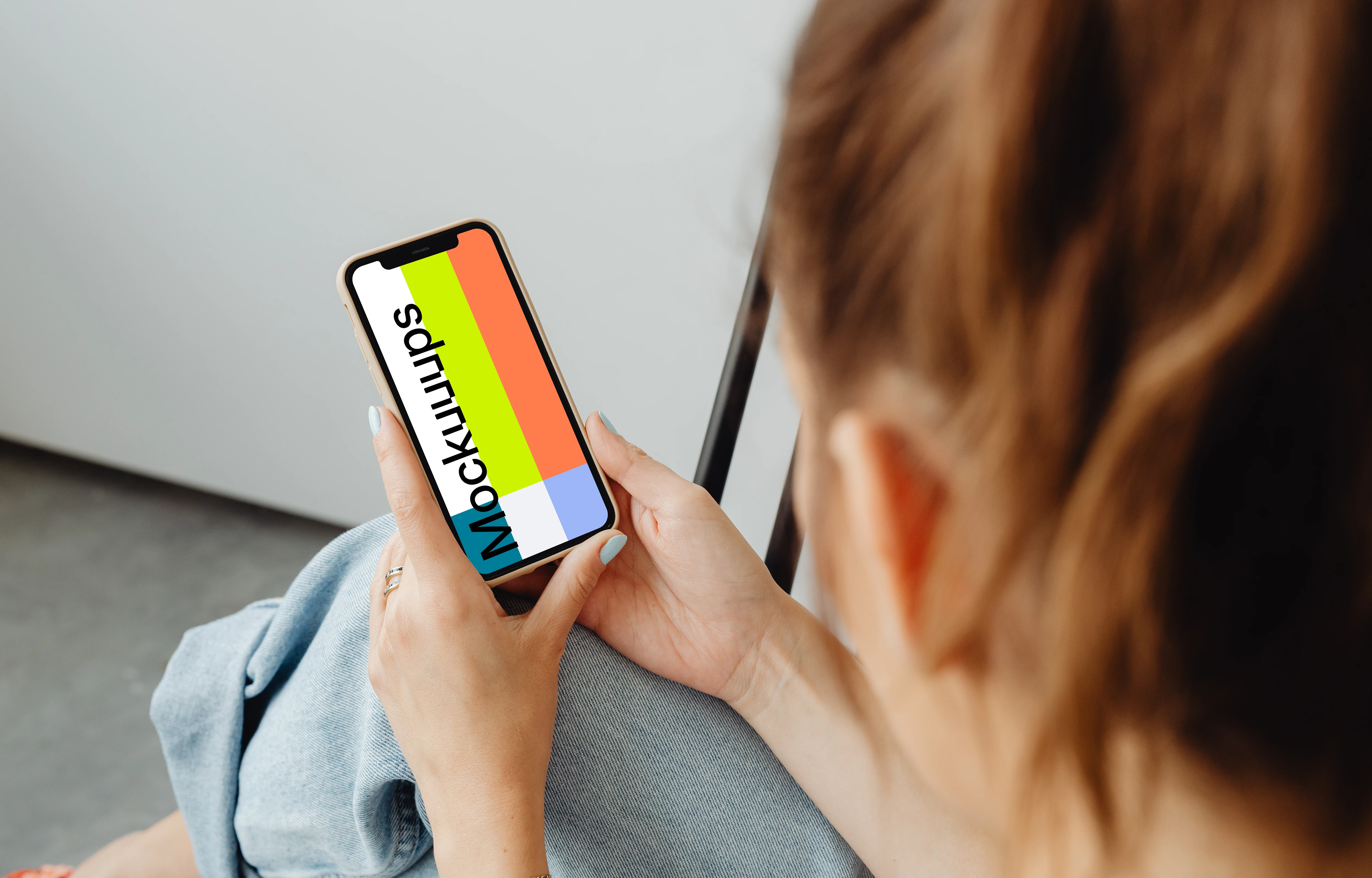 Woman holding iPhone 12 mockup