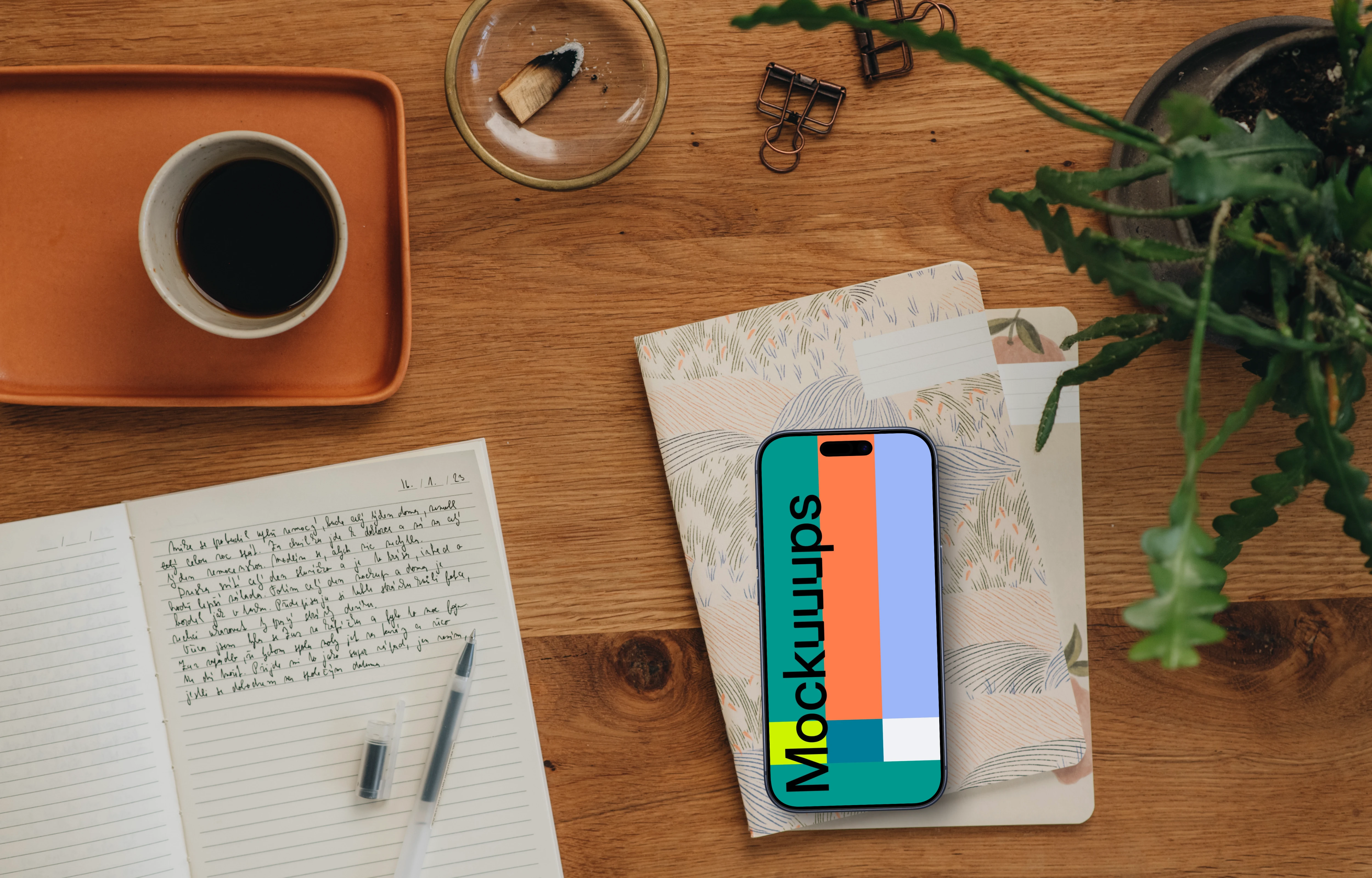 Styled journaling scene with an iPhone mockup