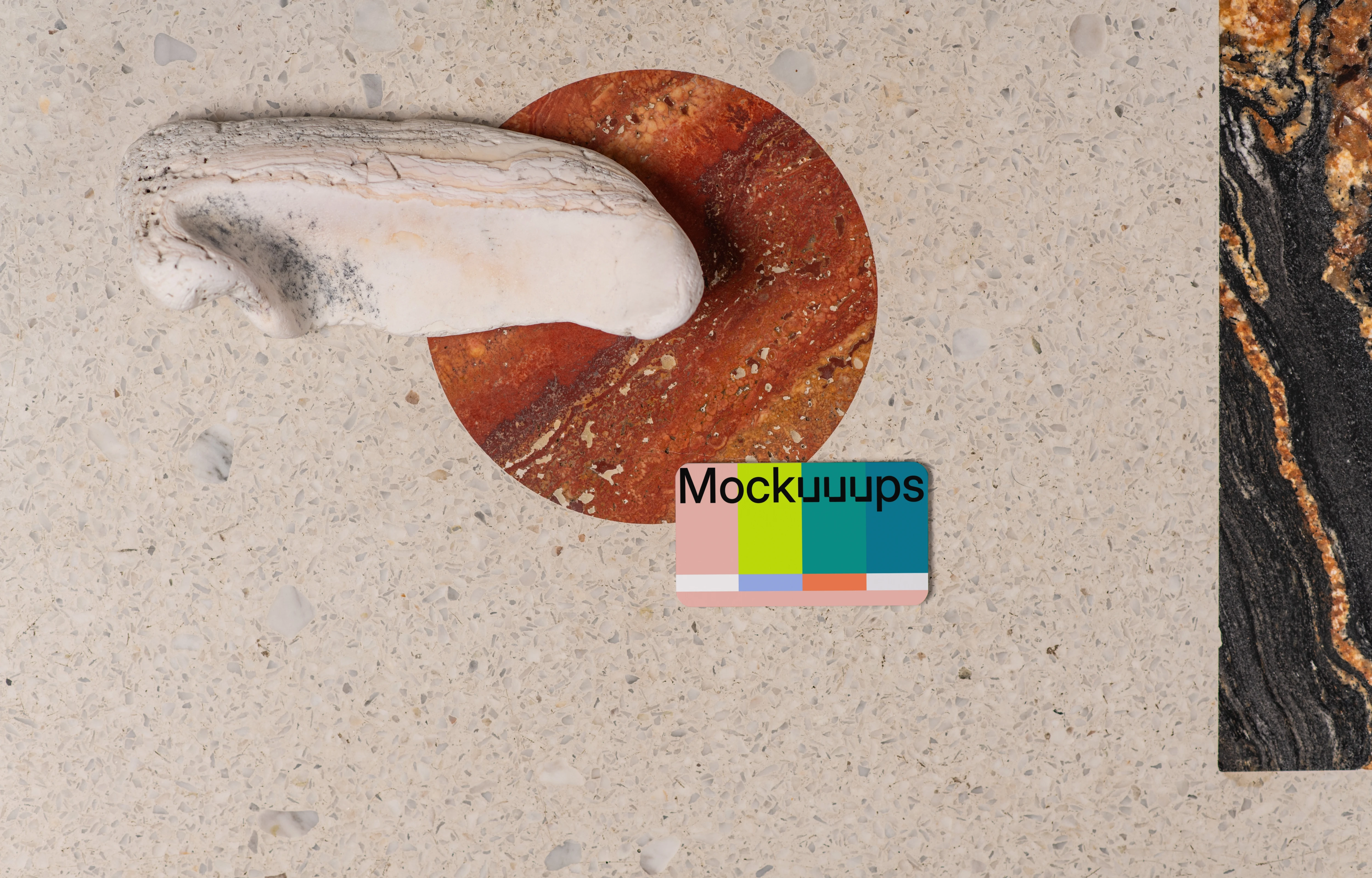 Business card mockup on a terrazzo surface with abstract accents