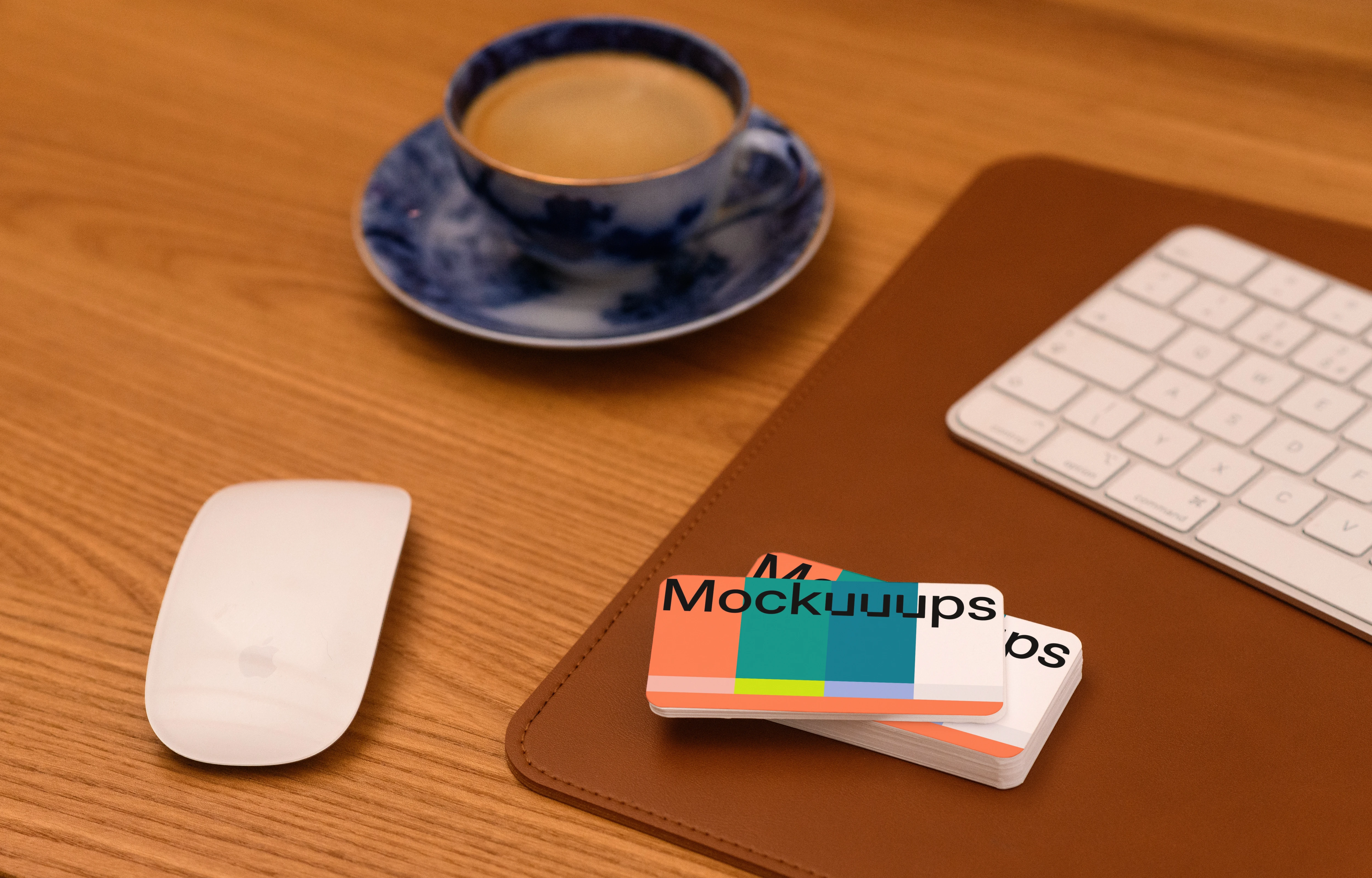 Business card mockup on a wooden desk with office items