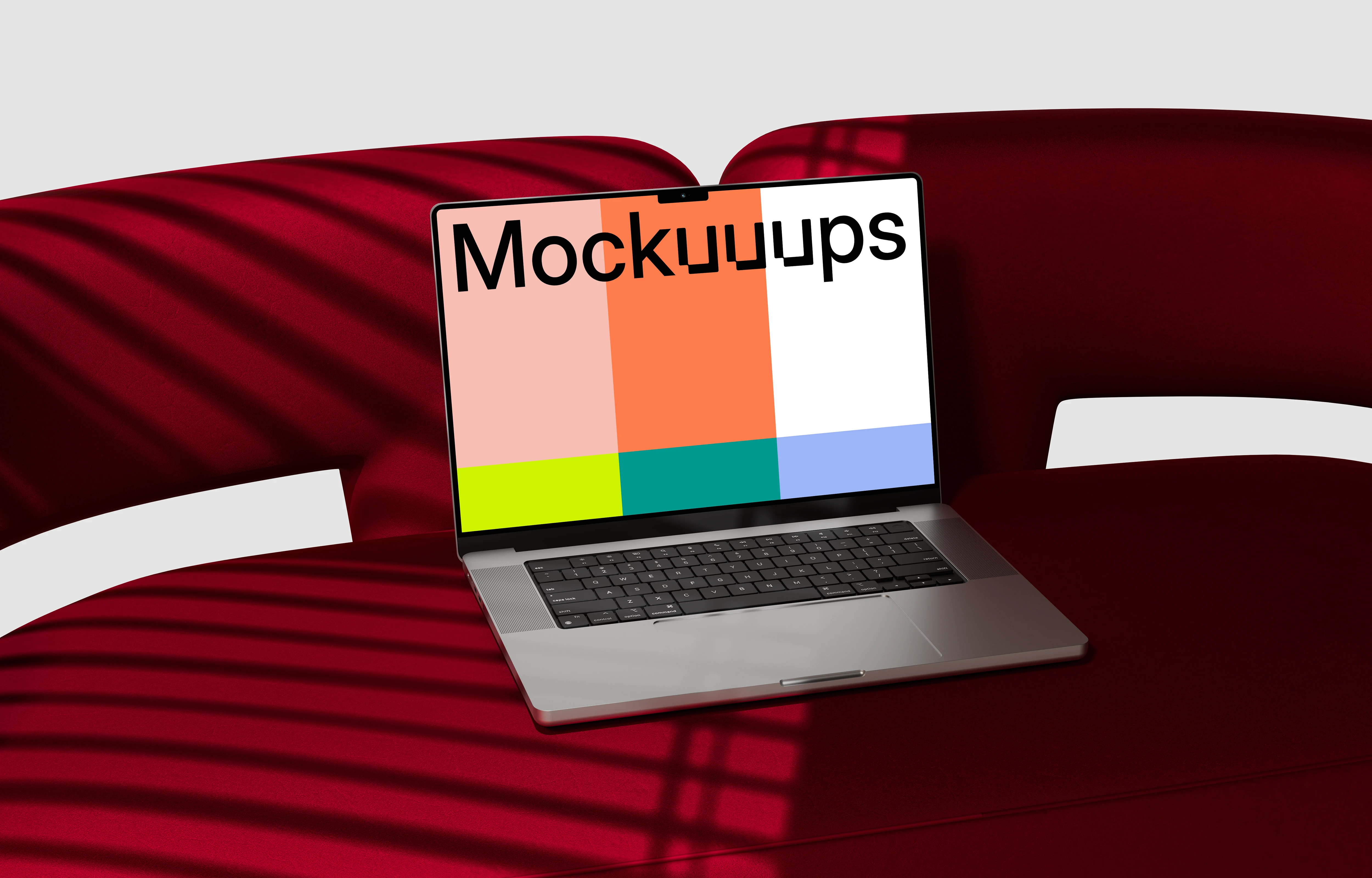 MacBook Pro mockup on a red curved sofa