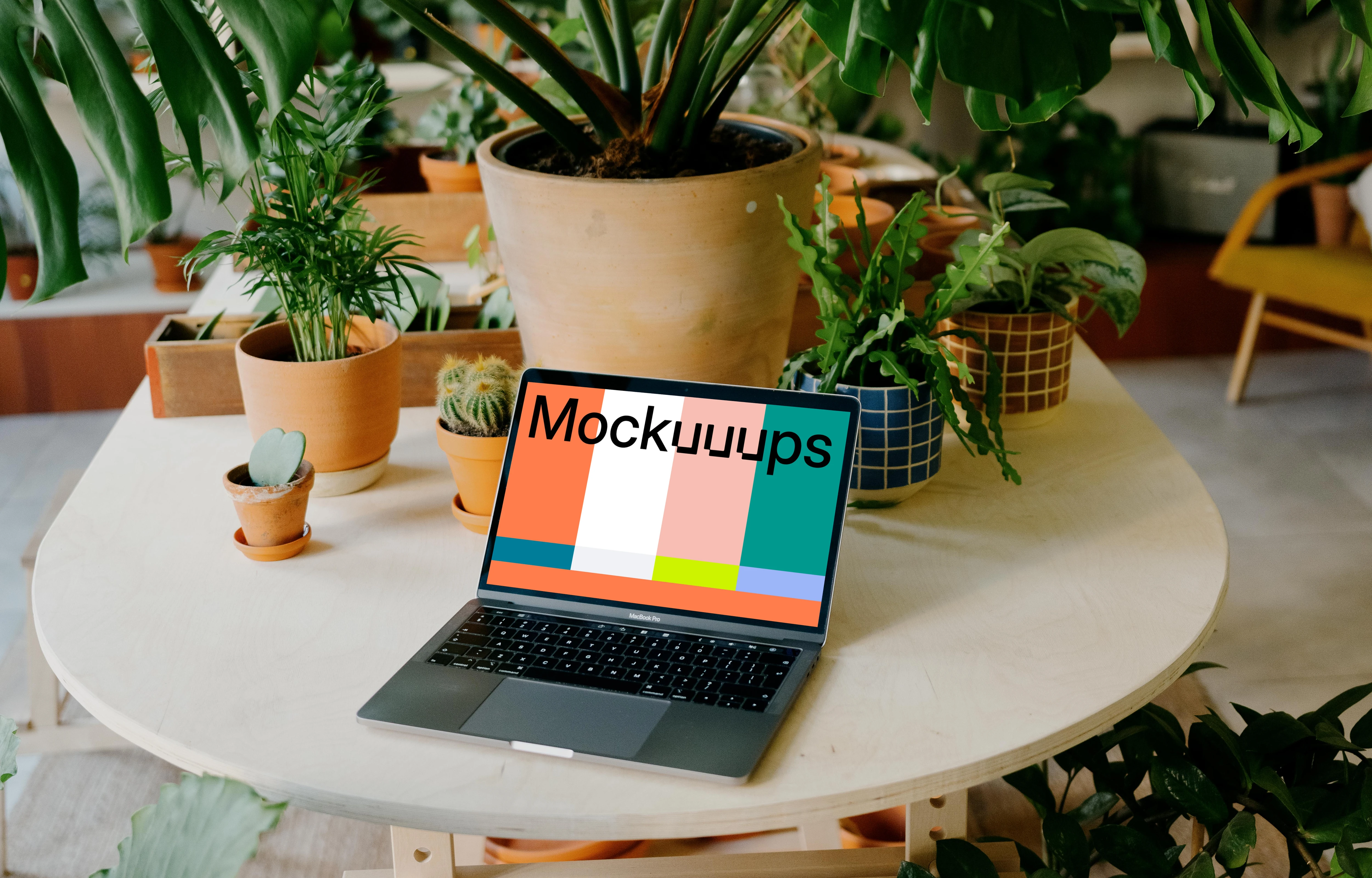 Grey MacBook Pro mockup on a round table