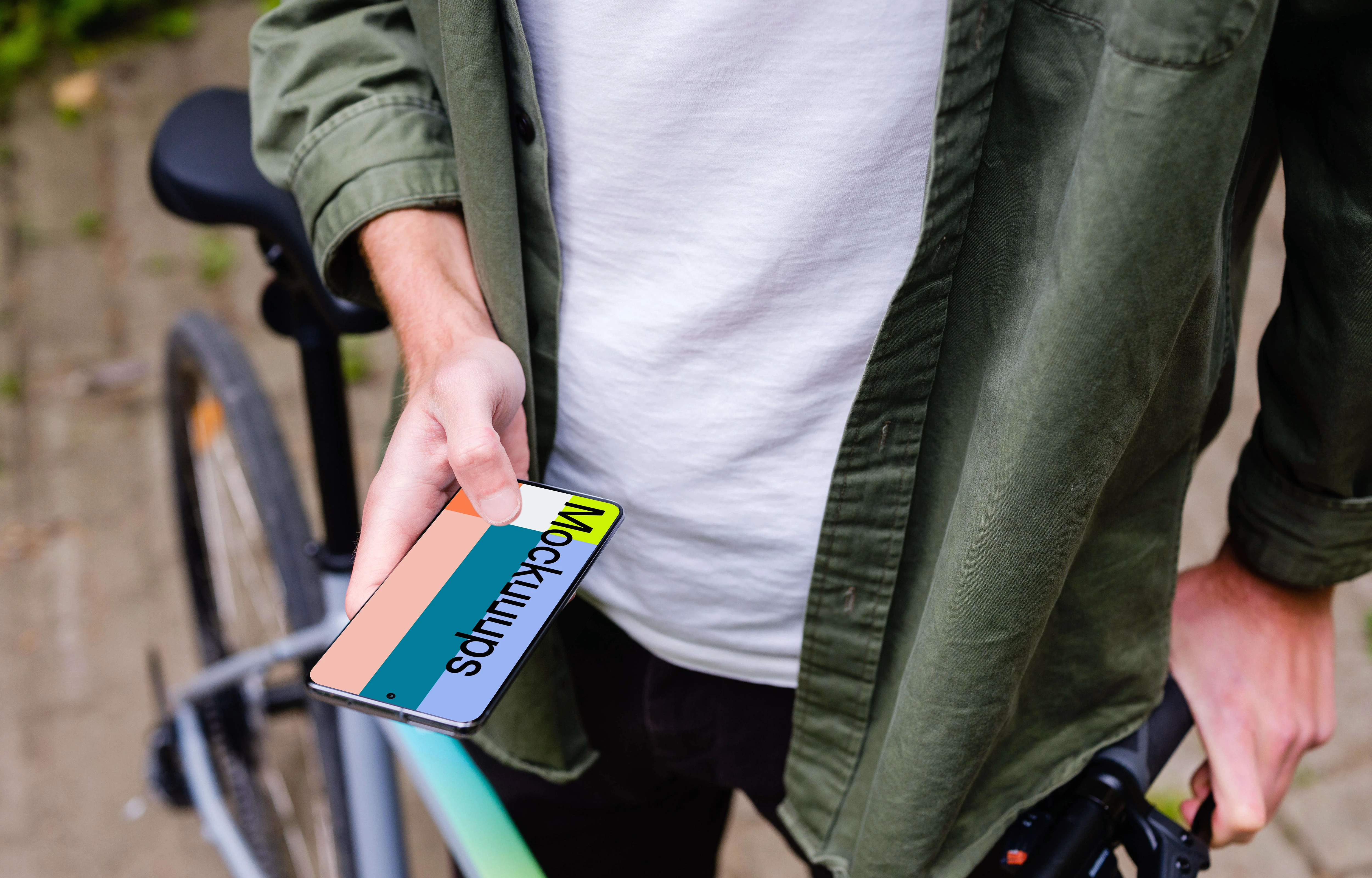 Free Holding Samsung S20 mockup in front of a bike