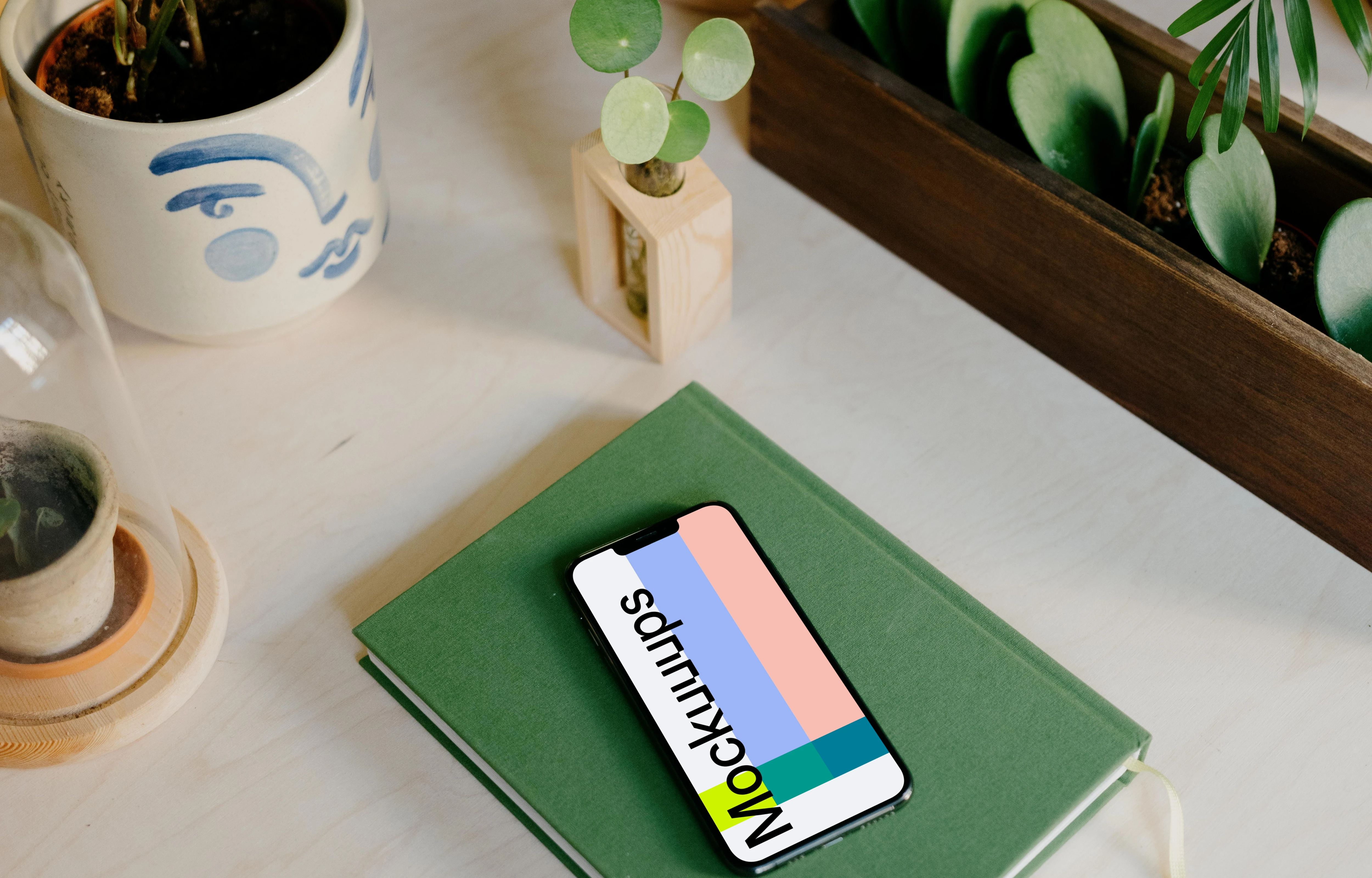 iPhone 13 Pro on a green notepad