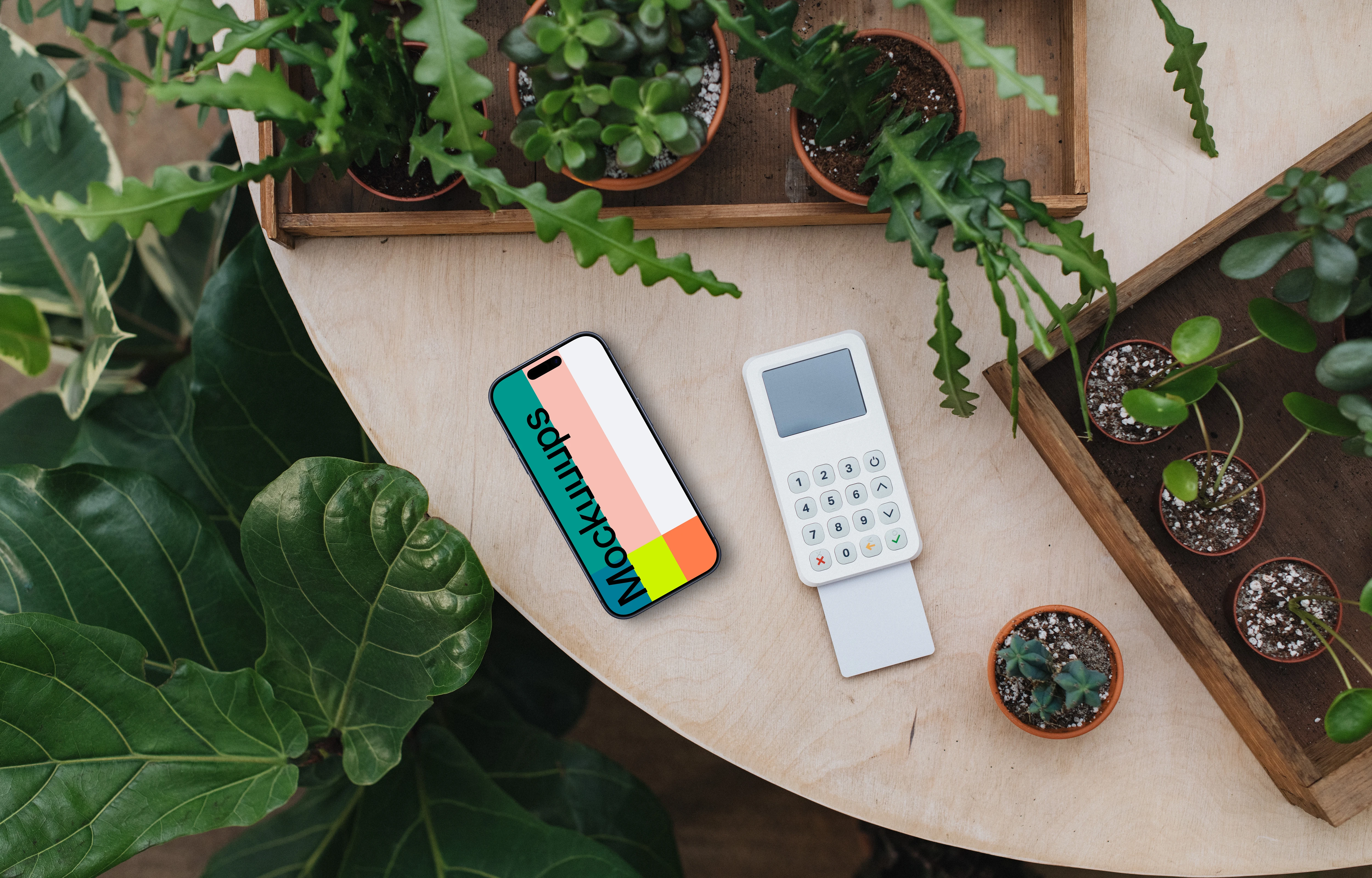 iPhone mockup amongst lush greenery with card terminal