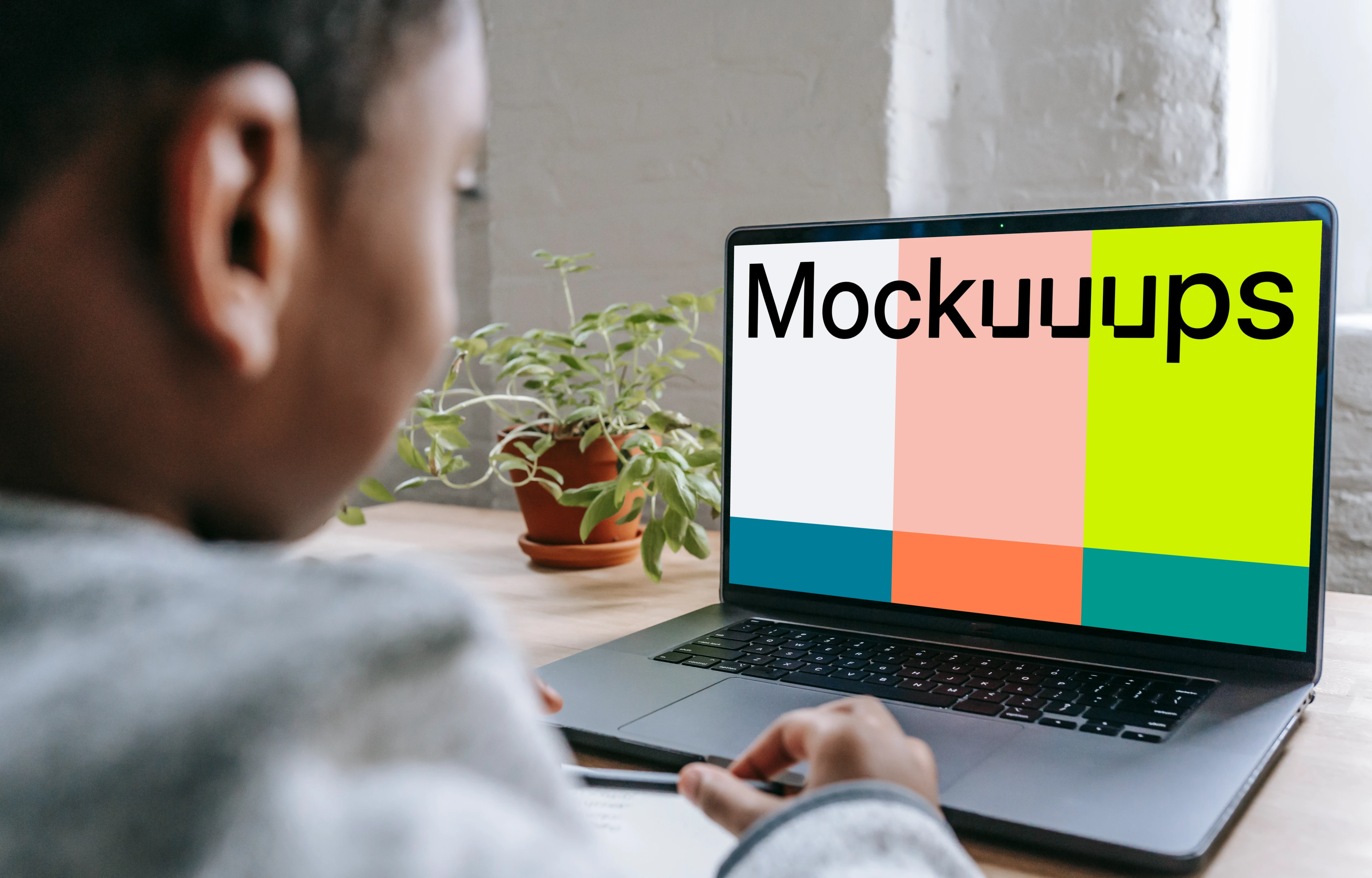 Little boy using a gray MacBook Pro mockup